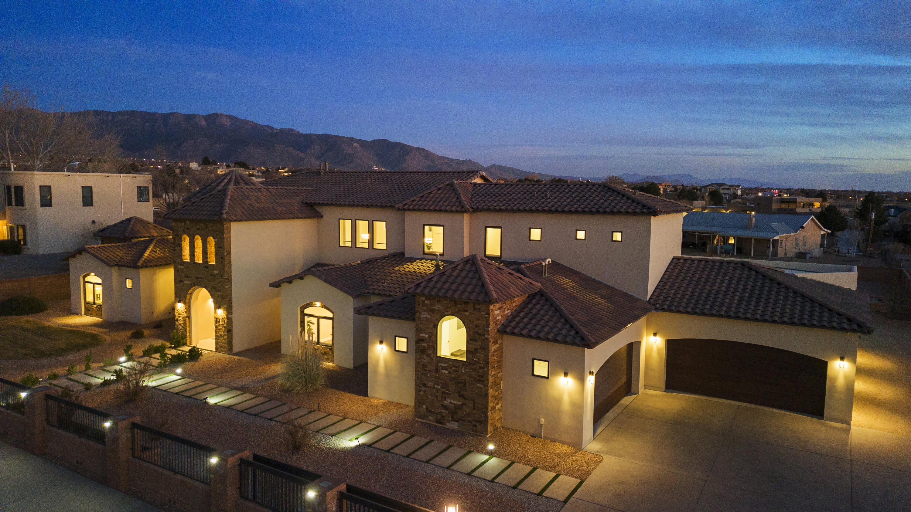 This stunning 6240 sq ft custom built home nestled in the desirable North Albuquerque Acres. Constructed in 2017 this luxurious residence offers 5 spacious bedrooms, 6 elegantly appointed bathrooms, providing ample space for both relaxation and entertaining, movie theater room, private bar room, 4 car garage, two primary suites on both levels. As you step inside you, you'll be greeted by high coffered ceiling with beautiful venetian plaster, an open floor plan that seamlessly connects to living areas. The gourmet kitchen is a chefs dream, featuring top of the line appliances, custom cabinetry, large center island perfect for gatherings, The expansive primary suite  offers a private retreat with a spa-lik