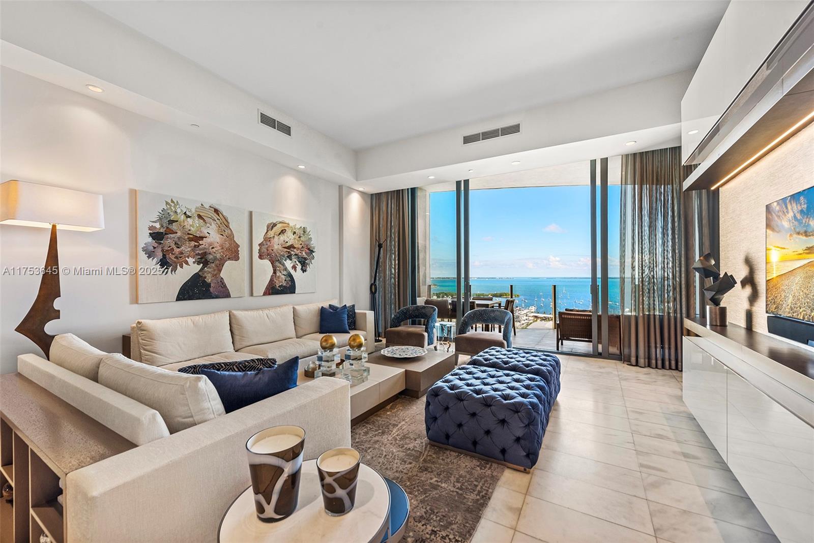 Experience elevated luxury at Park Grove in this fully remodeled 19th-floor residence with breathtaking Biscayne Bay views. Completely renovated and re-designed by Adriana Hoyos, this 3-bedroom, 3.5-bath home features white marble floors, custom millwork, and an Italkraft kitchen with Sub-Zero fridge/freezer, Wolf gas range, and steam oven. The spacious primary suite offers a private balcony, dual walk-in closets, and a spa-style bath with soaking tub and double vanities. Two en-suite bedrooms, an oversized office with built-ins, and a hidden storage wall complete the layout. Five-star amenities include 24/7 valet, concierge, 4 pools, gym, spa, private dining, wine cellar, and theater. Enjoy the ultimate Coconut Grove lifestyle