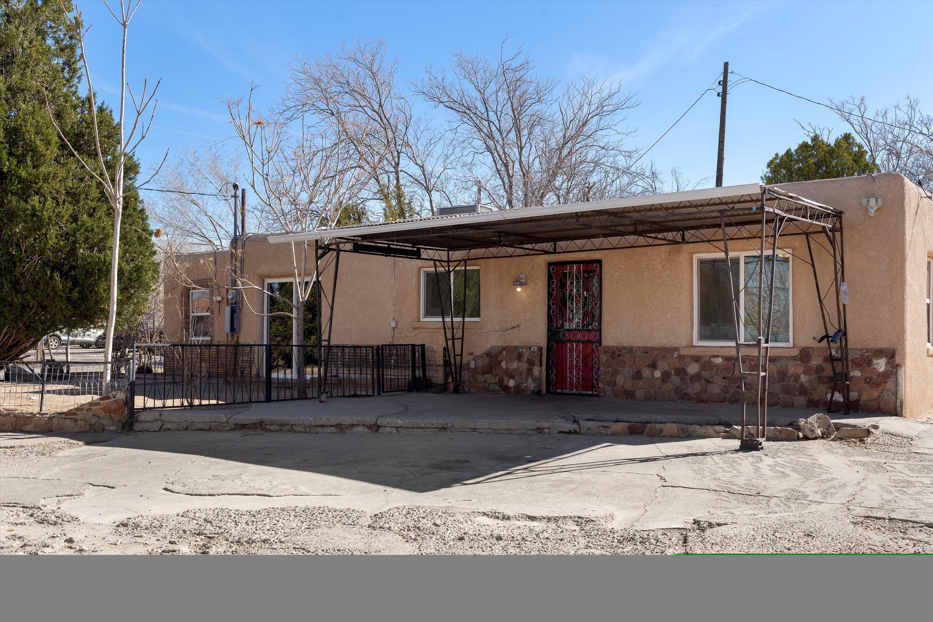 Experience timeless adobe construction in this 3-bedroom, 1-bath home located in Albuquerque's North Valley. The efficient floorplan features refrigerated air, a durable TPO roof, and sleek granite countertops in the kitchen. The spacious quarter-acre lot invites gardening, play, or entertaining, while the detached garage provides extra storage or workshop potential. Tucked away on a quiet road yet mere minutes from Paseo Del Norte corridor, you'll enjoy both serenity and convenience. This captivating home is ready to become your new haven.