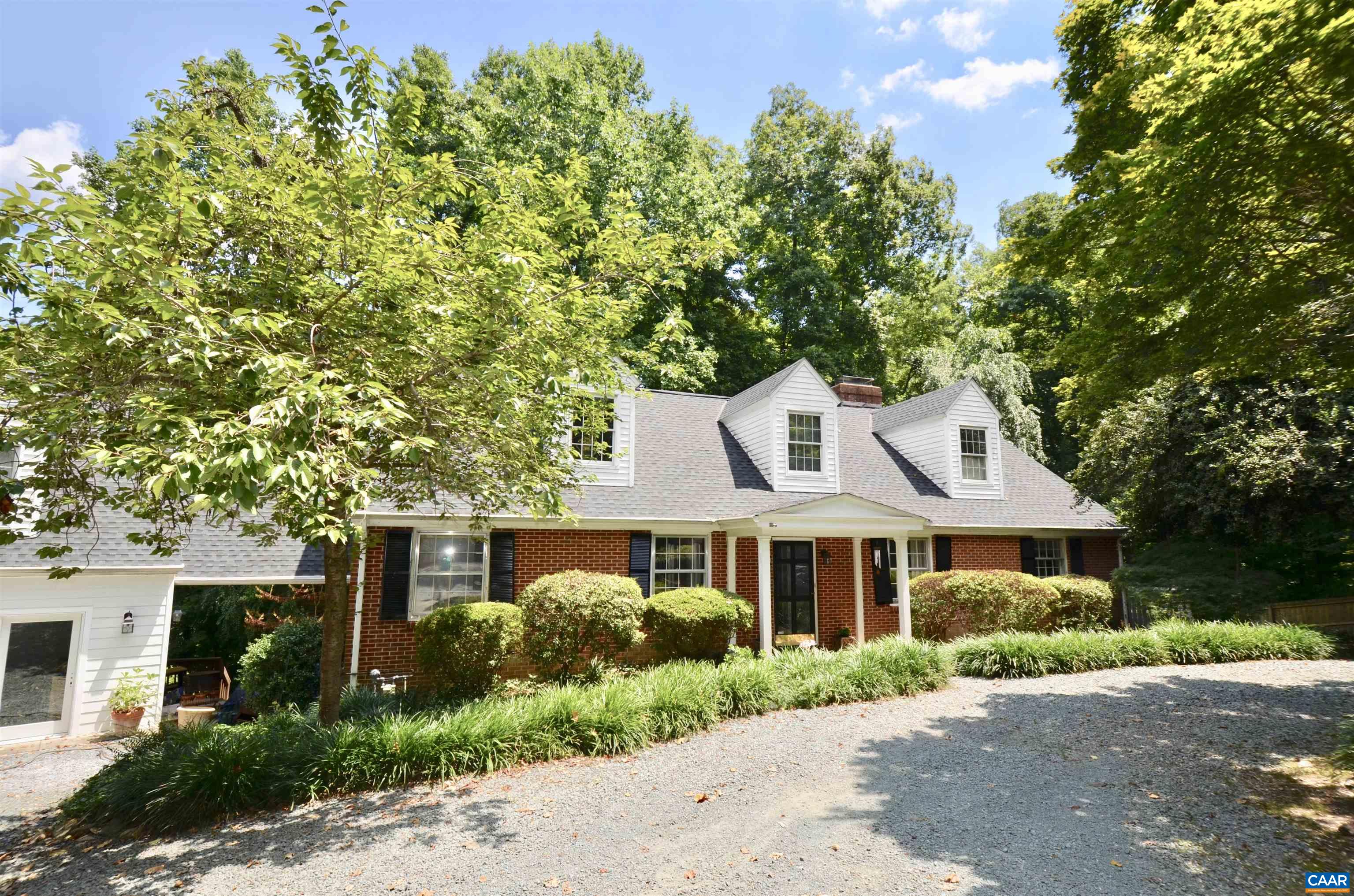 Hidden down a lane near UVA & Barracks Rd shops, find the ultimate in-town compound with privacy & flexible space on .92 acre!  Enjoy nature at home & in the guest house.  This gracious classic compound encourages entertaining both indoors and on 3 decks. Enjoy multiple primary suites, kitchens and bathrooms, three decks. Owner will finance half. Proven high income possible from one or more AirBnBs or rentals while living in main house. Great storage, closets & off-street parking.
