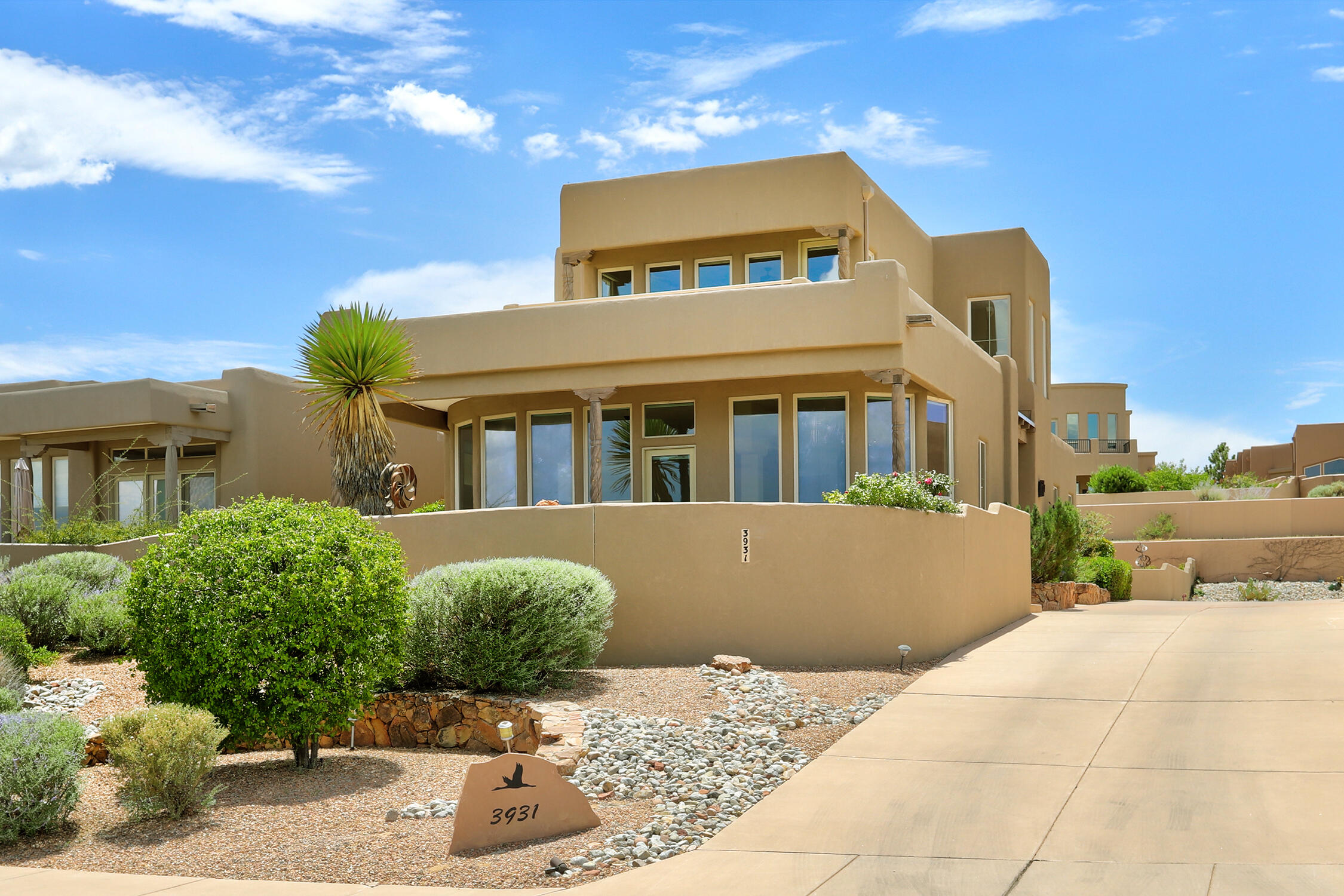 Gated custom home with a million-dollar view. Unwind in your private courtyard, enjoying the Sandia sunrise or sunset, the lush or golden bosque belt, the tranquil Rio Grande river and at night the twinkling city lights. Scott Patrick Homes designed each residence with its lot location in mind, featuring ample windows to capture views from the living room, kitchen and master bedroom. Skylights throughout the house to capture natural light. Private master suite upstairs offers a large balcony, jetted tub, and spacious walk-in closet. Additional features include a newer TPO roof (2023) and new expansive Trex decking. The property is fully landscaped with a front courtyard fountain and a cascading backyard fish pond. Come see this amazing one-owner home. Carpet allowance w/ acceptable offer.