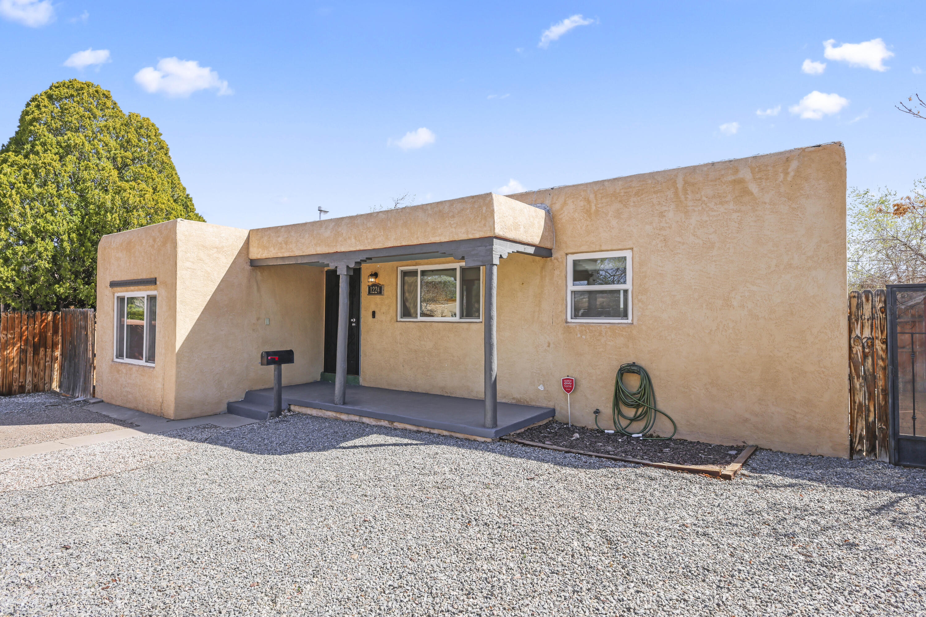 Seller offering a seller credit of $2500!  Welcome home to a charming 1940's residence ideally located within walking distance to UNM Hospital, the UNM School of Law, and North Golf Course. The inviting property boasts a newly installed roof (2023, with warranty) . Home features a brand-new swamp cooler for energy-efficient climate control. The updated kitchen impresses with a stylish butcher block countertop and new stainless steel sink. Flooded with natural light , the home exudes simple charm and comfort . Nestled in a highly sought-after area with sidewalks, grocery stores (Whole Foods & Smiths) , and schools nearby, the property offers both convenience and character.