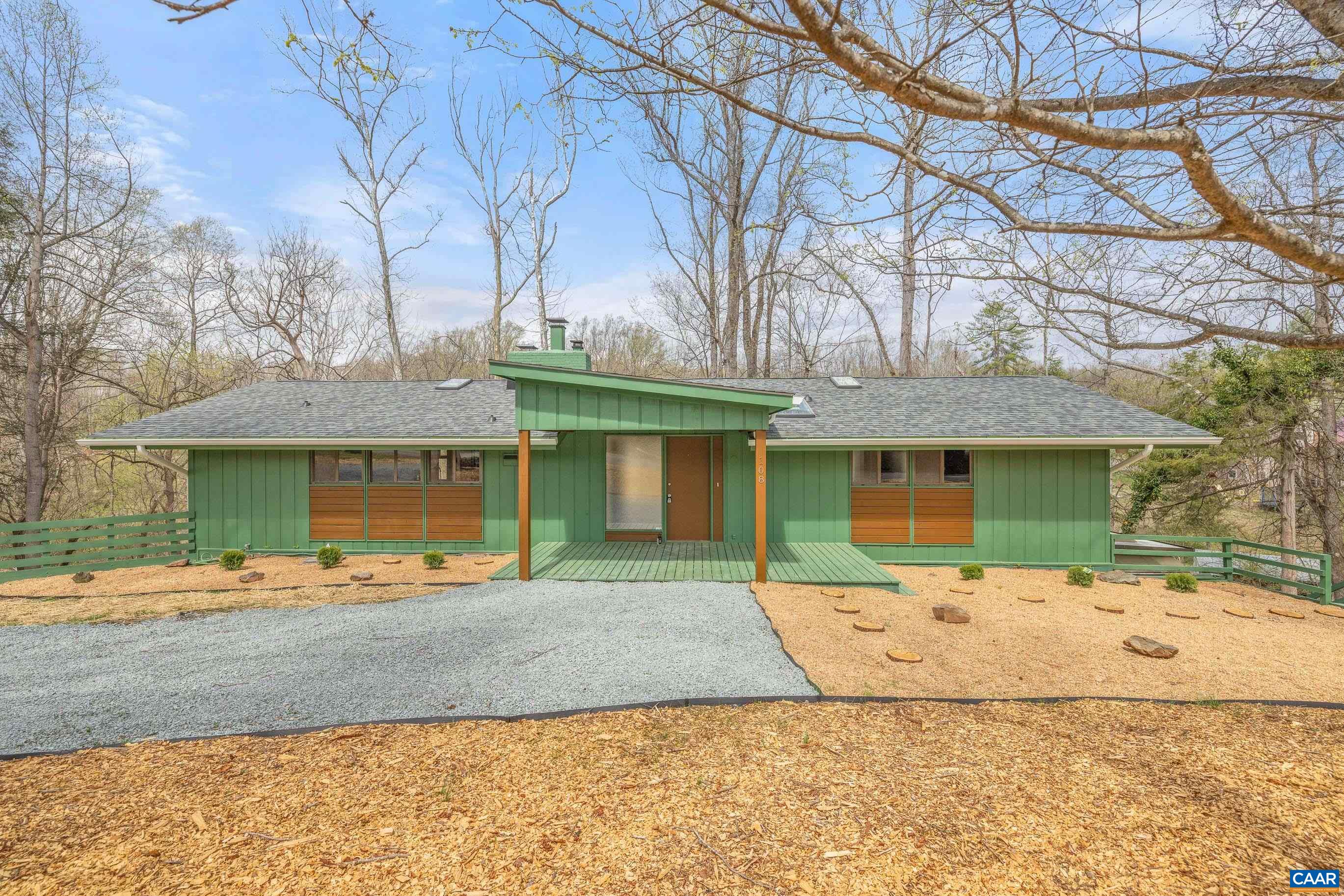Wonderfully Upgraded Mid-Century Modern Retreat! Experience the perfect blend of nature, tranquility & modern elegance in this beautiful home on 1.5 serene acres, just minutes from Downtown Charlottesville. Thoughtfully designed landscape & brand-new modern front porch welcome you home. Step inside the light-filled foyer, where oversized exposed wood beams stretch across the entire length of the home, complementing the stunning wood-plank vaulted ceiling that enhances the spacious 1st floor. Enjoy your morning coffee on the new rear deck, overlooking the babbling stream that winds thru the back of your property. Brand-new kitchen is a chef’s dream, featuring SS appliances, 2 pantries, new soft-close white cabinets, butcher block counters, an oversized single-basin sink, new LVP flooring, stylish light fixtures & a custom built-in eat-in area with storage. Bathrooms have been fully updated with new LVP flooring, modern lighting, new vanities & upgraded commodes. Unwind by the cozy fireplace in the living room, or head downstairs to the finished basement, complete with a coffered ceiling rec room, exposed wood beams, new LVP flooring, and 2nd large wood-burning fireplace. New roof, new skylights, new gutters & freshly painted!