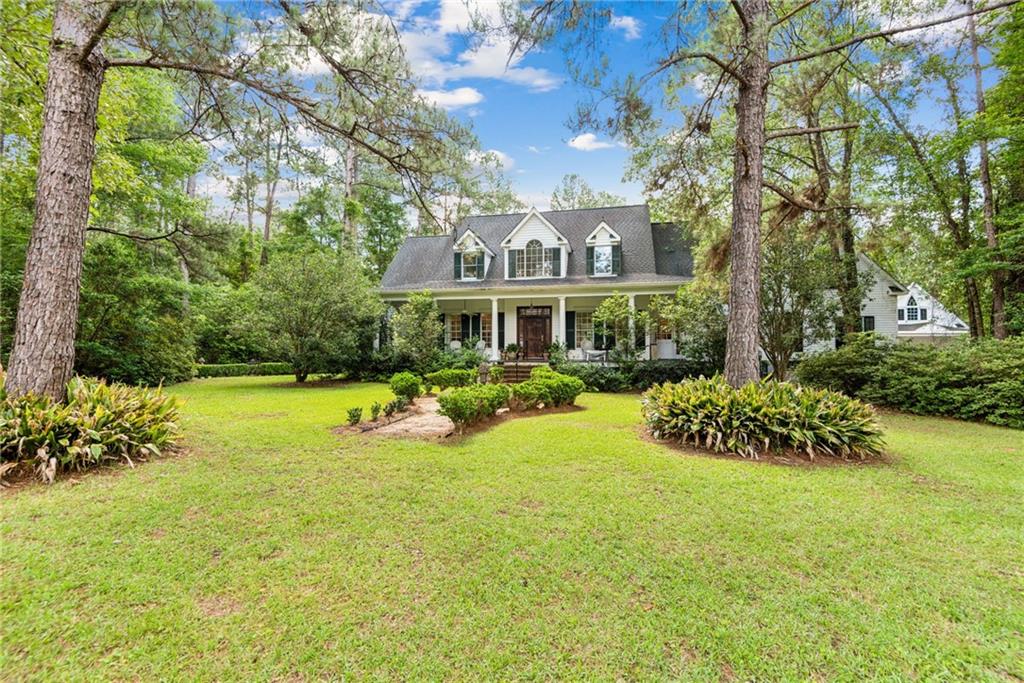 Welcome to your slice of paradise nestled on 9.13 acres of pristine land! This enchanting estate boasts timeless elegance and modern amenities, offering a serene retreat from the bustle of city life. Step inside to discover the allure of pine flooring, meticulous craftsmanship showcased by triple crown molding, adding a touch of sophistication to each room, all overlooking a tranquil pond. The heart of the home lies in its gourmet kitchen, adorned with custom cabinets and equipped with top-of-the-line appliances, inspiring culinary creativity and culinary delights. Rest assured, this home is not only beautiful but also built to last, with copper wiring and plumbing & 2 BRAND NEW AC UNITS ensuring both reliability and peace of mind for years to come. The home also features a separate 774 sq ft 1 bed, 1 bath apartment above the garage (included in square footage). Indulge in the serenity of the outdoors with a charming Pigeonnier, a hidden Chapel, pond and dock, for leisurely afternoons spent fishing or simply soaking in the natural beauty. For the industrious at heart, a spacious workshop awaits, complete with central AC, providing the ideal space for crafting, tinkering, or pursuing your passion projects. Adjacent to the workshop, a convenient tractor shed offers ample storage for outdoor equipment, ensuring that both work and play are seamlessly accommodated. Escape the ordinary and embrace the extraordinary lifestyle offered by this remarkable property, where luxury meets tranquility in perfect harmony. Don't miss your chance to make this dream retreat your reality! **Owner is a licensed agent**