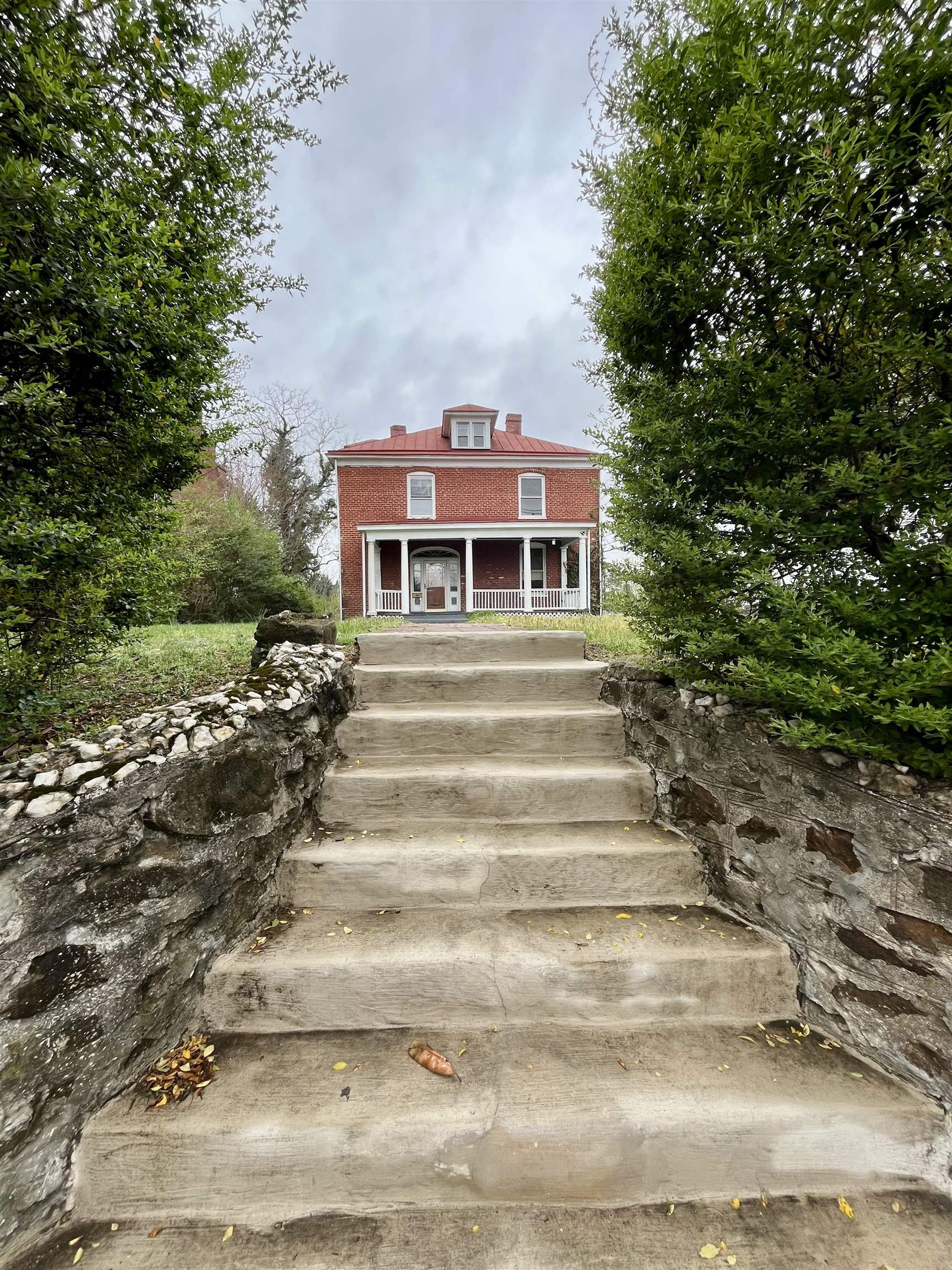 This gem has returned to the market at no fault of the seller! Assessed at $566,300!! Rare opportunity to own a piece of all-brick history on Ridge Street in Charlottesville! Featuring 5 bedrooms and 2 full bathrooms this property is in need of TLC but is a wonderful investment opportunity. It would make for a fantastic full time residence, rental or fix and flip. Walking distance to UVA, shopping and dining. The metal roof appears to have been recently painted. The retaining wall around the property is topped with quartz for a timeless appeal. Huge bedrooms with high (approximately 12ft) ceilings. Potential to add an additional finished room/bedroom in the walk up attic. The possibilities for this home are huge!! Call your favorite Realtor to take a tour today! Sold as-is.