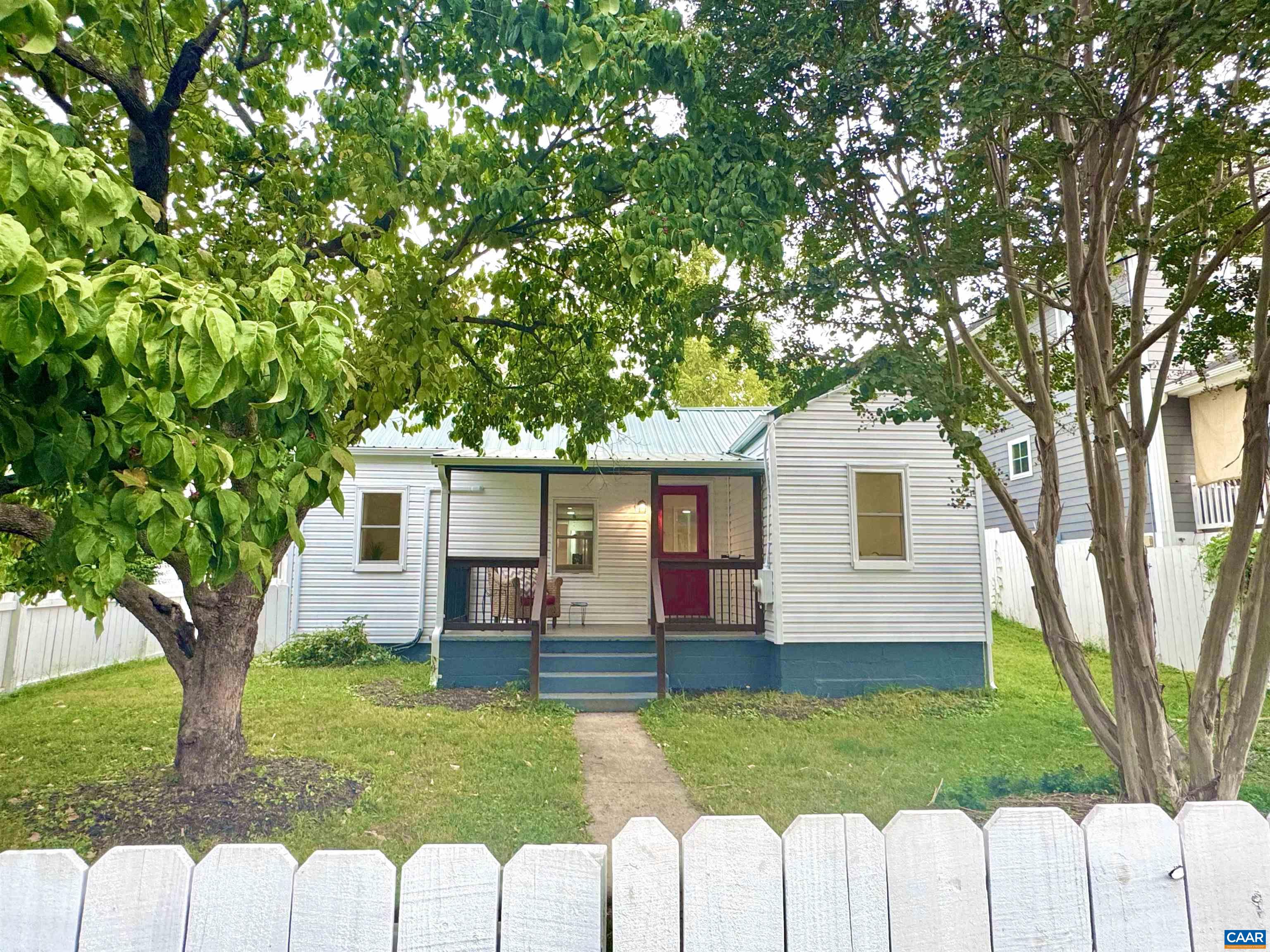 New Price! This darling Belmont cottage packs a punch! You will adore the white picket fence the surrounding the front yard, and the covered porch where you'll enjoy the view of Carter Mountain and watch baseball games right across the street at Quarry Park. The new metal roof adds to the charming exterior style and vintage flair.  Inside, the home has been completely renovated and features modern conveniences throughout.  New white shaker cabinets are found in the kitchen plus sleek stainless appliances, and a large tiled shower in the bathroom. Ductless HVAC system was added for heating and cooling. There’s even a spacious mudroom off the back with a sliding barn door. At 850 square feet, it's cozy but smartly laid out with 2 bedrooms plus an office. Just 1 mile to the Downtown Mall, minutes to UVA, and around the corner from I64, it's a great location! If you're looking for an affordable, low-maintenance, move-in ready home in a fantastic location, this one's got the charm and the updates to match. Don't miss this opportunity to see this one before its gone!