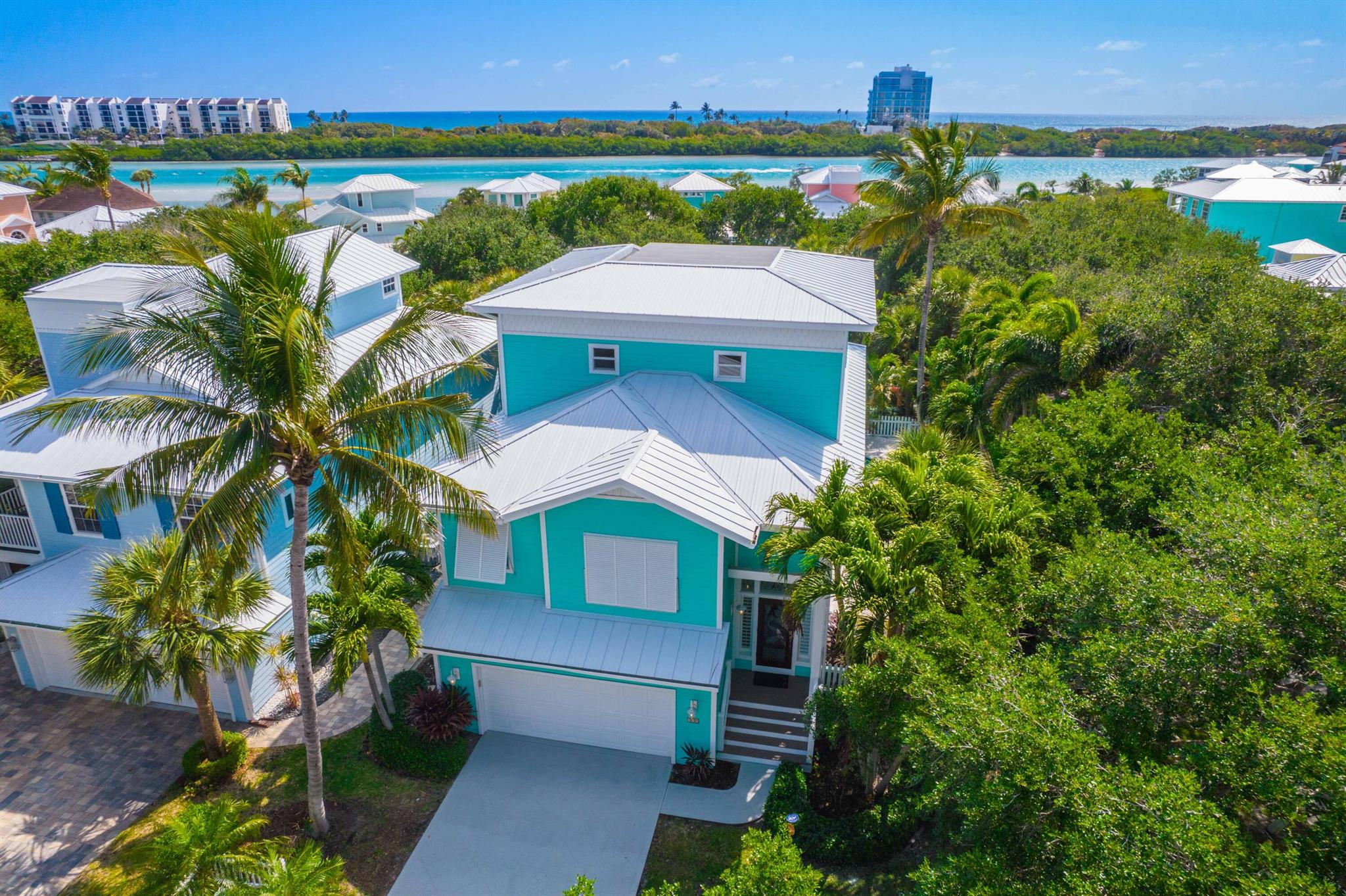 Tucked away in the heart of Tequesta along the Intracoastal is highly sought-after Key West Village. this charming 4-bedroom, 4-bath pool home offers the perfect mix of island character and relaxed coastal living. With only 25 homes in the entire community, Key West Village is a hidden gem, secluded and private, but has great walkability to the great shops and restaurants in Tequesta!.Inside, the main level welcomes you with a bright, open kitchen featuring a large island, granite countertops, stainless steel appliances, and warm wood cabinetry with under-cabinet lighting. Natural light fills the space, making it feel open and inviting. Just off the kitchen and Great Room is the covered porch overlooking the private pool--great for laid-back afternoons or entertaining friends SEE MORE. The private third-floor master suite boasts spectacular Intracoastal and ocean views, a spacious walk-in closet, wet bar, separate laundry room, and its own outdoor porch with wide water views.
The first floor includes two en suite bedrooms with walk-in closets, a second laundry room, and a cabana bath with direct access to the pool and tropical outdoor living space.
Additional features include impact windows, plantation shutters, private paddleboard storage, and direct launch access to the Intracoastal Waterway&#x14;perfect for those who love an active, outdoor lifestyle.
Whether you're looking for a peaceful retreat or a vibrant community close to everything, this home offers the best of coastal living in one of Tequesta's most beloved neighborhoods.