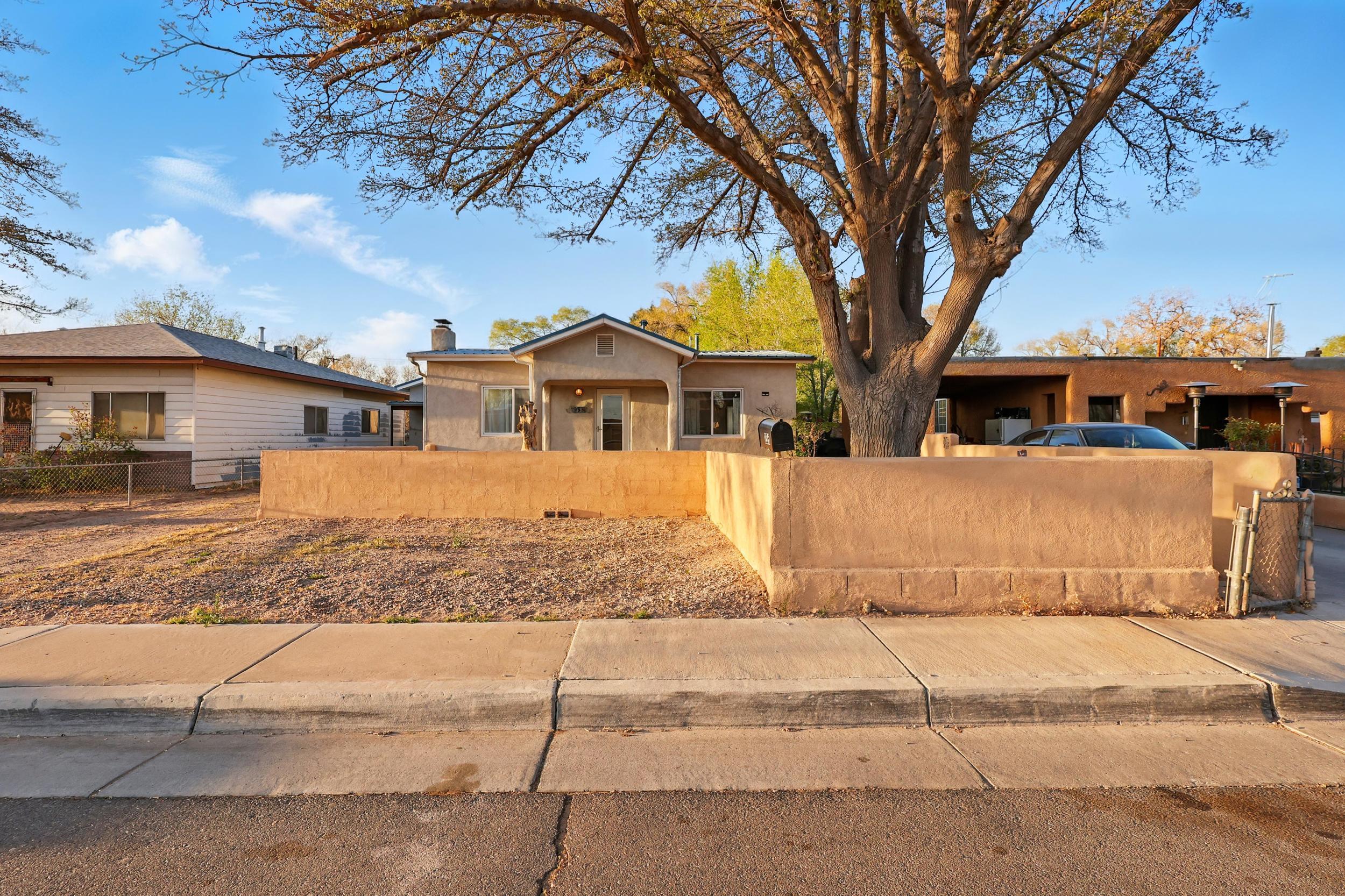 Charming 2-bedroom, 2-bathroom home in Albuquerque's North Valley. This 1,341 sq ft residence features beautiful hardwood floors, a cozy fireplace, and a spacious backyard with ditch rights. Recent updates include a new roof (2021), water heater (2019), and kitchen appliances as well as the front bathroom has been updated and the home was converted from evaporative and Mini Splits were installed. An attached in-law suite offers additional living space or potential rental income. Located near the National Hispanic Cultural Center and local parks, this home provides both comfort and convenience. Experience the blend of historic charm and modern amenities in this well-maintained property.