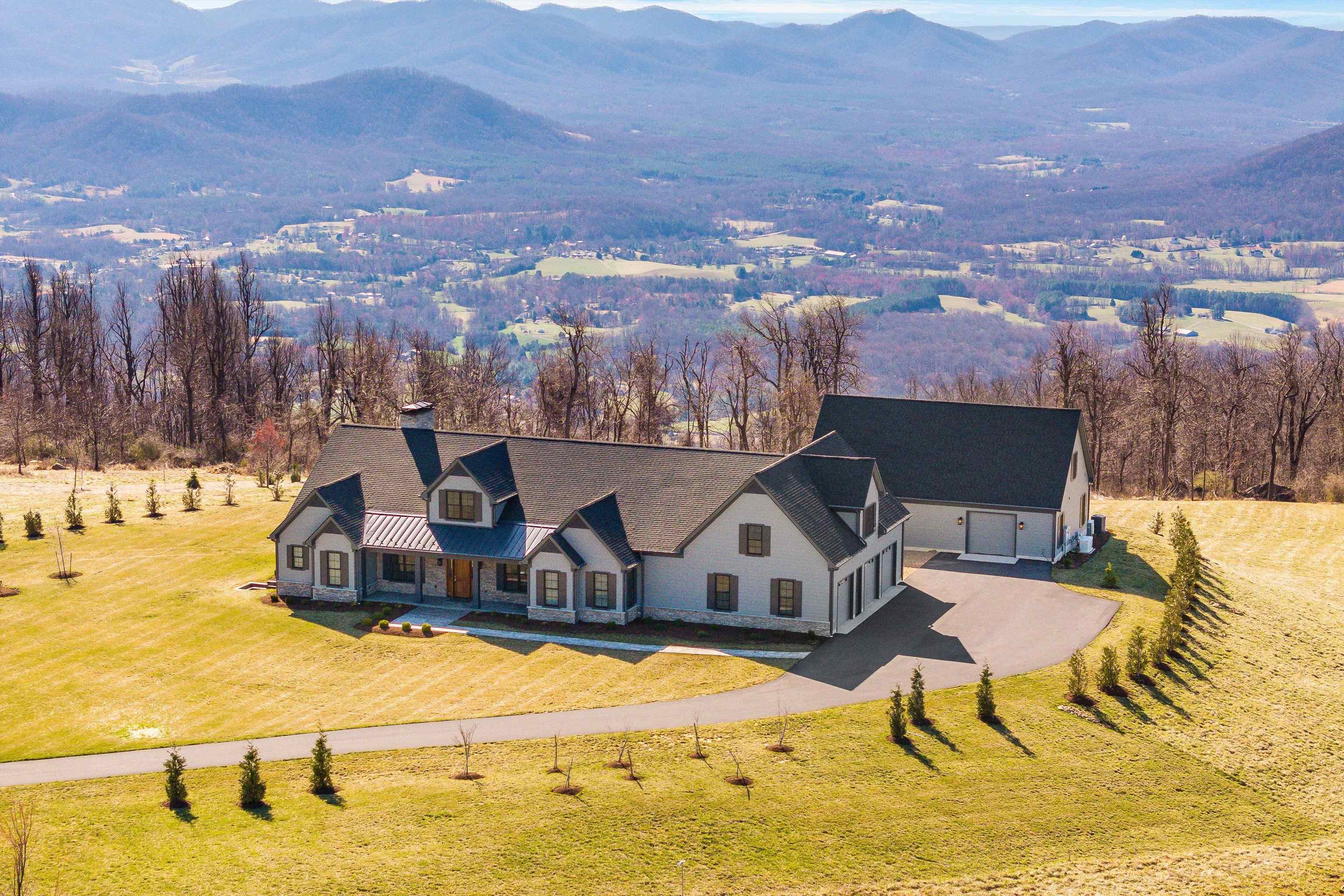 Afton Mountain Estate brings true meaning to “million-dollar” views.  Escape to unparalleled luxury and breathtaking natural beauty in this exceptional custom-built residence on 5.77 pristine acres atop Afton Mountain, with direct adjacency to the iconic Blue Ridge Parkway, Skyline Drive, and I-64. This meticulously crafted home offers an extraordinary lifestyle, blending sophisticated design with unparalleled access to outdoor adventure and stunning exquisite mountaintop views. A culinary haven featuring an open floor plan, a striking stone fireplace as its centerpiece, and a Viking cooktop and Zephyr exhaust system are perfect for creating memorable meals or delighting guests with private, chef-catered dinner parties.Detached Shop with Finished Upstairs Space awaits the motorsport enthusiast or classic car collector. A versatile addition perfect for hobbies, a home business, or guest accommodations, easily accessible via a covered breezeway. The shop is 30’x50’space with a half bath, hot and cold running water,commercial grade lighting.Enjoy the Vineyards, breweries, and Skiing within just a few miles. A short drive to UVA in nearby Charlottesville, VA, and the opportunity to get lost in the quaint historic downtown of Staunton.