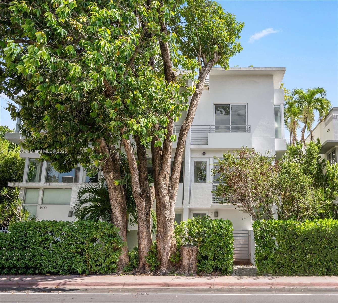Experience refined living in this stunning three-story townhome, ideally located just steps from the iconic Lincoln Road Mall. Featuring sleek modern design and soaring ceilings, this exquisite residence offers two spacious bedrooms, two elegantly appointed bathrooms, and a striking glass enclosed, third floor flex space perfect as a sophisticated home office or lounge. Enjoy seamless indoor outdoor living with private terraces on every level, culminating in an expansive rooftop retreat that provides panoramic views of vibrant Miami Beach. Additional highlights include two privates, covered parking spaces with secure gated entry for added convenience. This is a rare opportunity to own a truly one-of-a-kind residence near world-class shopping, restaurants, dining, and steps from beach.