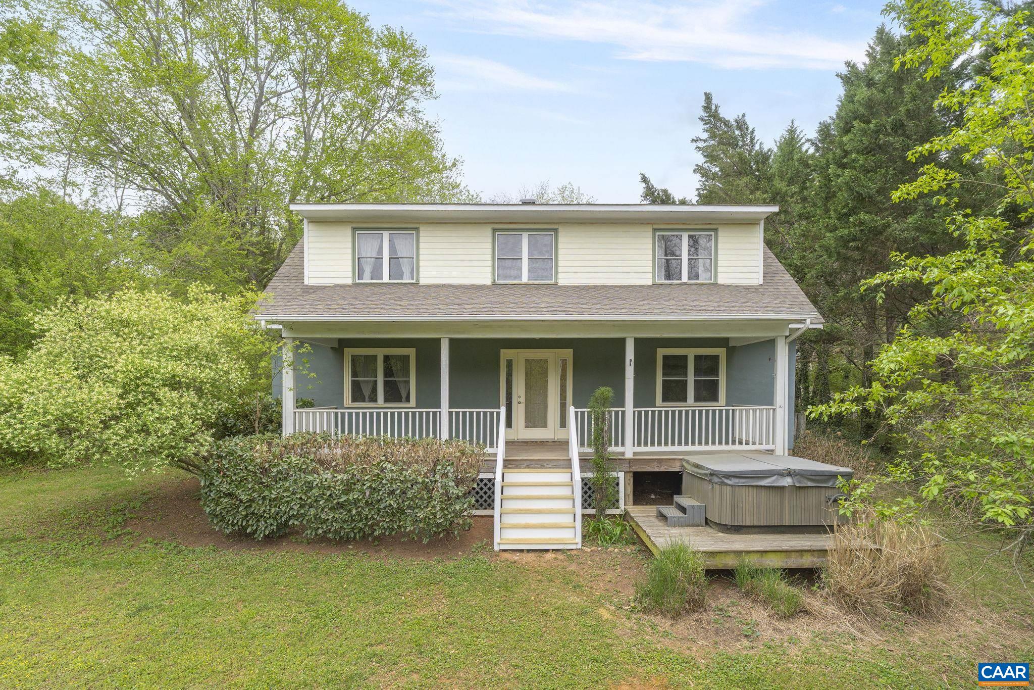 This delightful home boasts numerous updates and improvements that enhance both its aesthetic appeal and functionality. Perfect location only 15 minutes to UVA and Shopping at 5th Street Station and close to Dr. Ho's Humble Pie, Pippen Hill and Loving Cup Vineyards, and Albemarle Ciderworks. The design offers flexibility, allowing you to choose between a primary bedroom on either the first or second level. Built-in shelves provide practical storage solutions while adding architectural interest. The interior is further elevated by tray and vaulted ceilings. The kitchen is a true centerpiece, designed with entertaining in mind. Its open floor plan seamlessly connects the culinary space to the dining area, allowing for effortless interaction with guests. The exterior of the home is as inviting as its interiors, offering ample opportunities to connect with nature and loved ones. Whether you have a passion for gardening or enjoy hosting gatherings, the expansive outdoor space accommodates a variety of activities.