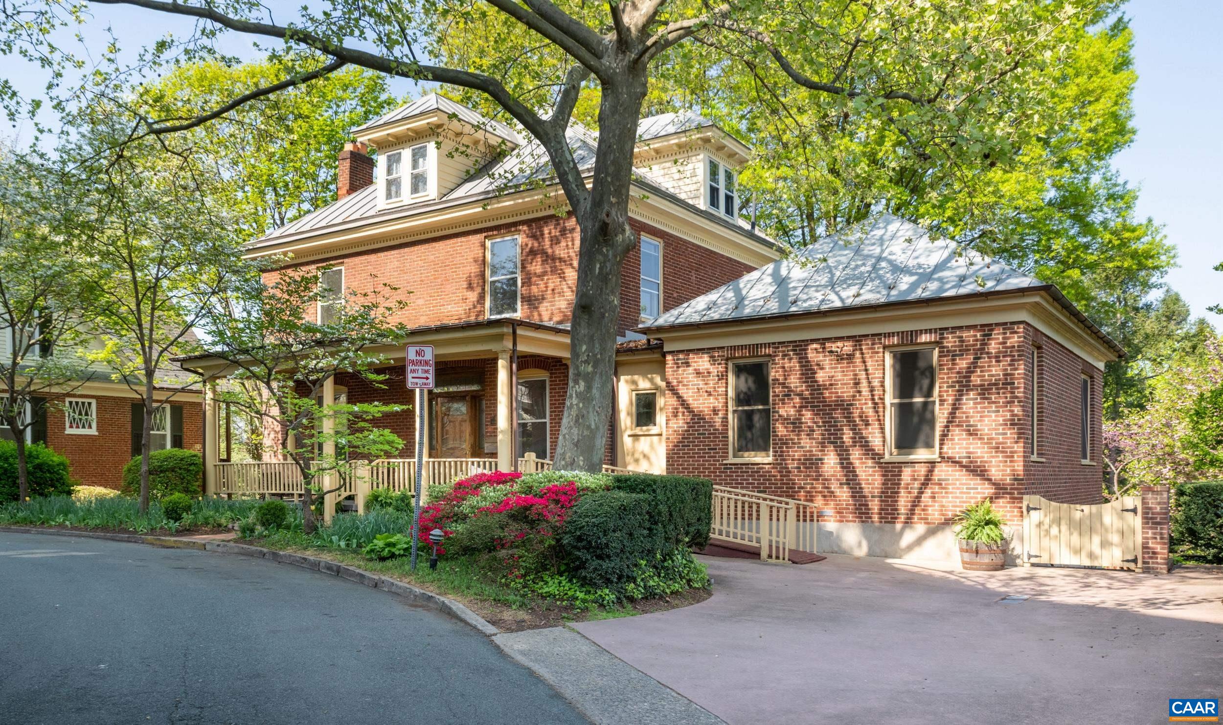 AMAZING OPPORTUNITY! 150K price reduction for prestigious home on coveted Altamont Circle on a large, landscaped lot. This fine brick residence blends charm, history and location. Assessed at $1.9M, it is worthy of your creative vision to update and open the space. See the virtual reno pics! Expansive front porch opens to a grand foyer which leads to living/dining rooms, each with fireplace, as well as a 21st century lavish Owner’s Suite w/ generously sized BR, 2 WICs & custom bath with soaking tub, separate vanities, zero clearance shower & extra laundry stack. Upstairs find four sizable BRs, one with its own fireplace, another with a walk-up attic, and another that serves perfectly as a home office. At the rear of the home a kitchen & sunroom open to a deck with covered portico for dining while overlooking the city. Charming, fenced gardens below feature a patio, stone wall & koi pond. Elevated lot shows off a western view of urban landscape, framed by distant mountains! Terrace level includes separate laundry, full bath, storage, and a bonus room with access to back yard. Bonus space ideal for a rec room or home gym. Off street parking for several cars. Just 1500 feet to pedestrian mall & venues!