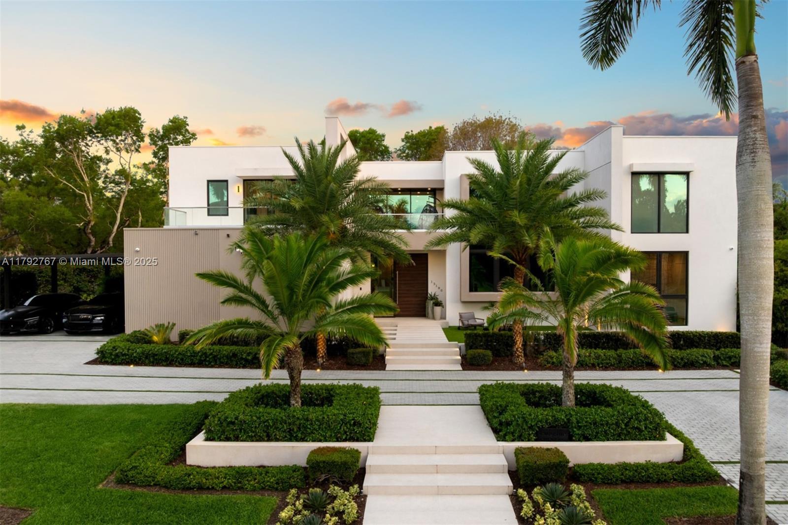 Modern architectural estate in Pinecrest featuring 6 bedrooms, 7.5 bathrooms, & a professional built theater/media room. Thoughtfully designed with an open-concept layout, including a guest bedroom, housekeeping suite, 2-car garage, laundry room, butler’s pantry, & family room on the 1st floor. Gourmet kitchen equipped with Miele and Wolf appliances. Elevator, generator, gas water heaters, & smart home integration. Outdoor highlights feature a summer kitchen, expansive covered terrace with electric screens, & oversized pool. Upstairs, a split floorplan offers a grand primary suite with his-and-hers closets, dual toilets, sinks, & showers, plus three additional bedrooms, each with en-suite baths & private balconies + a common family rm. Located in a secure gated community of only 4 homes.