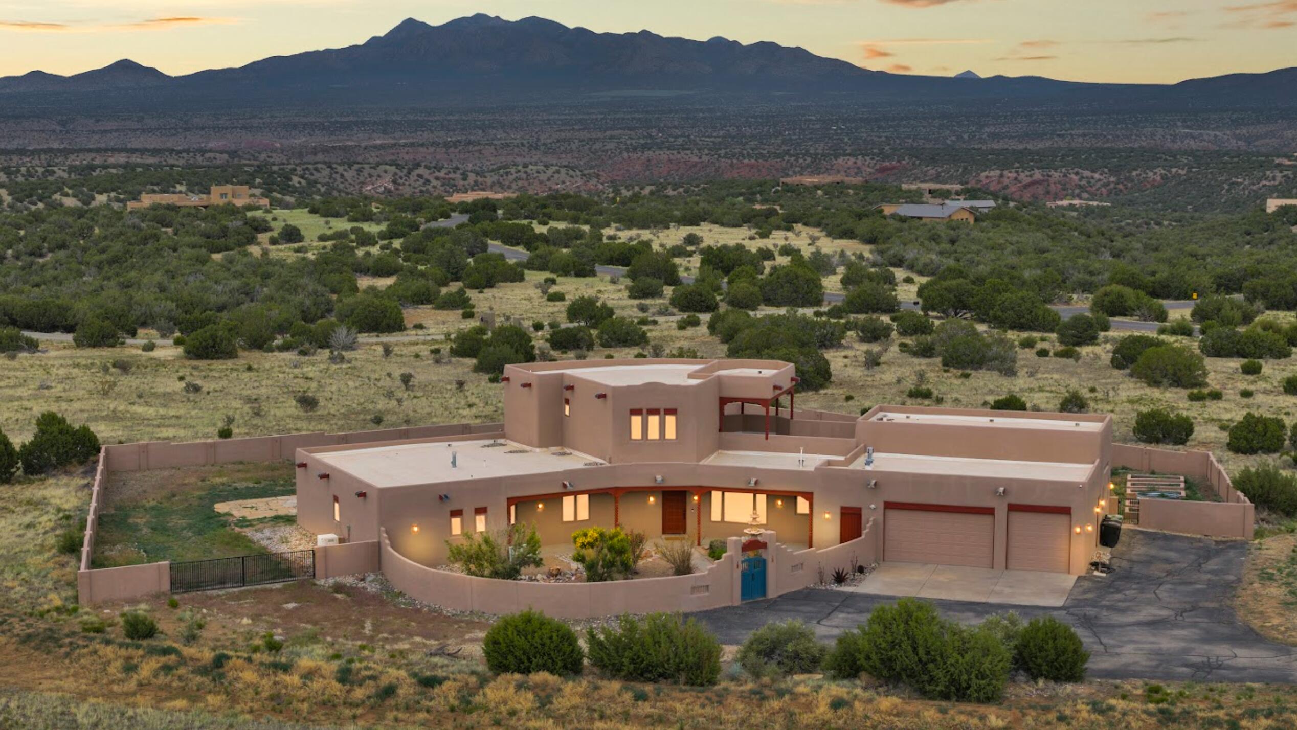 Luxury Rural Living Within Reach!   4,000 sq ft +on 10.5 acres in San Pedro Creek Estates! This 4-bedroom, 4-bath custom home offers two primary suites one on the main level with a spa bath and walk-in closet, and another upstairs with a private balcony.  The chef's kitchen features granite countertops, a built-in gas stove, abundant cabinetry, and a walk-in pantry. Sweeping views of five mountain ranges are enjoyed throughout, complemented by radiant in-floor heating, travertine tile, and a ample utility room. The walled backyard, 3-car garage, and multi-use workshop add comfort and flexibility.   for hiking, biking, and horseback riding. Horses and RVs welcome (refer to covenants.)  Just 30 miles to Albuquerque and 50 to Santa FE