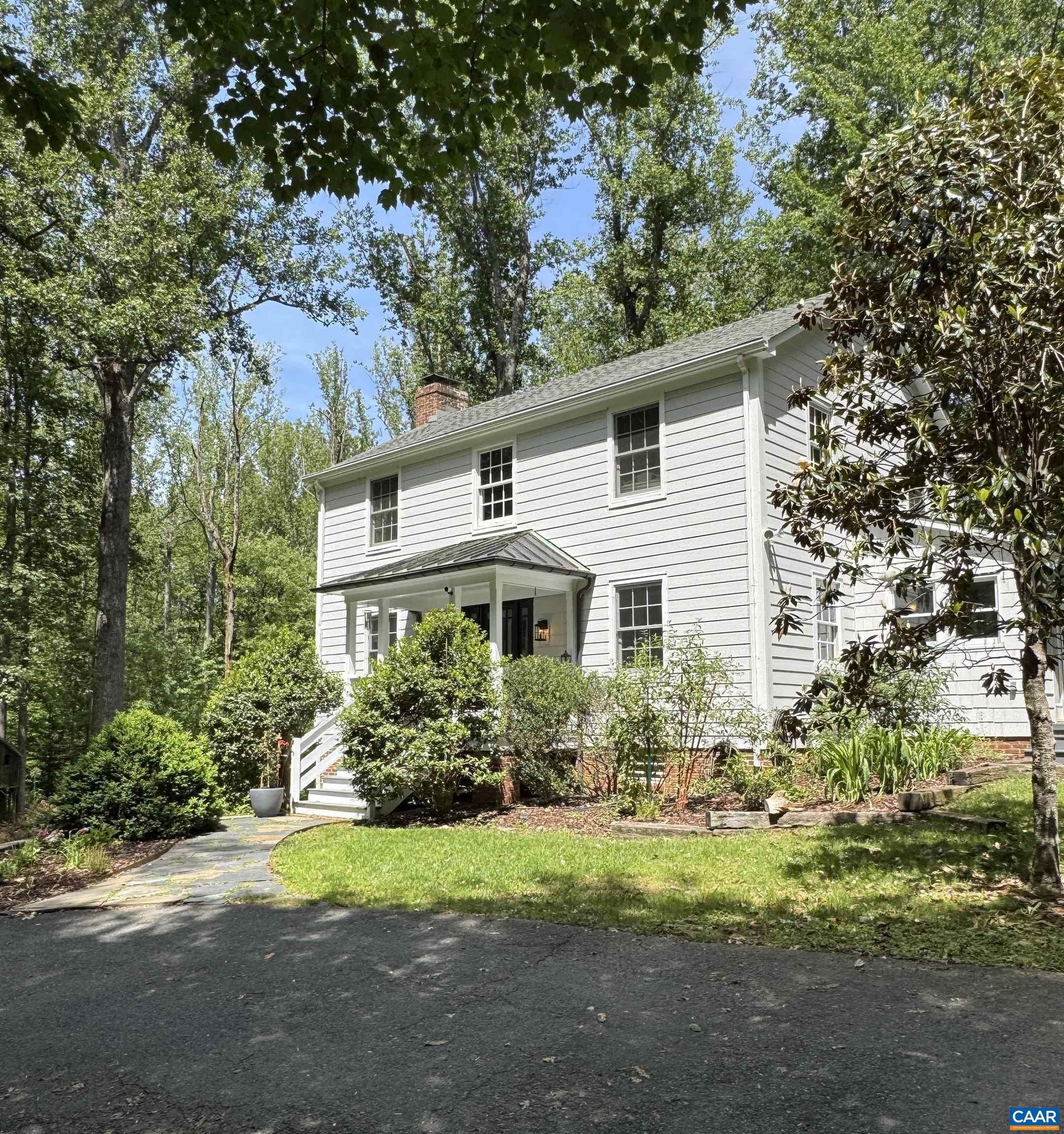 Charming home on an incredible lot on one of Ivy's most coveted streets. Enter the property and be enchanted with mature trees, green lawns, and surprising privacy.  Curb appeal galore with hardiplank siding, copper roofing and half round gutters on the front porch, and classic architectural lines. Main floor features a formal dining room and living room with wood burning fireplace which flows to the kitchen and lightfilled sun room currently used as an office. Second entrance off the driveway conveniently leads to the kitchen via mudroom offering wonderful amenities including storage benches, laundry, and powder room. Gas Wolf range, dishwasher, butcher block island, and dedicated pantry cabinets are highlights of the eat in kitchen. Heading upstairs you'll find the generous owner's suite with large tub, slate tile shower, and streaming natural light. Two more bedrooms and full bathroom in the hall complete the second floor. Walkout basement includes den with wood stove and ample storage space. Room to run and play or even add on in the future if you need more space. Get into the neighborhood at an approachable pricepoint and make it your own. Shown by appointment.