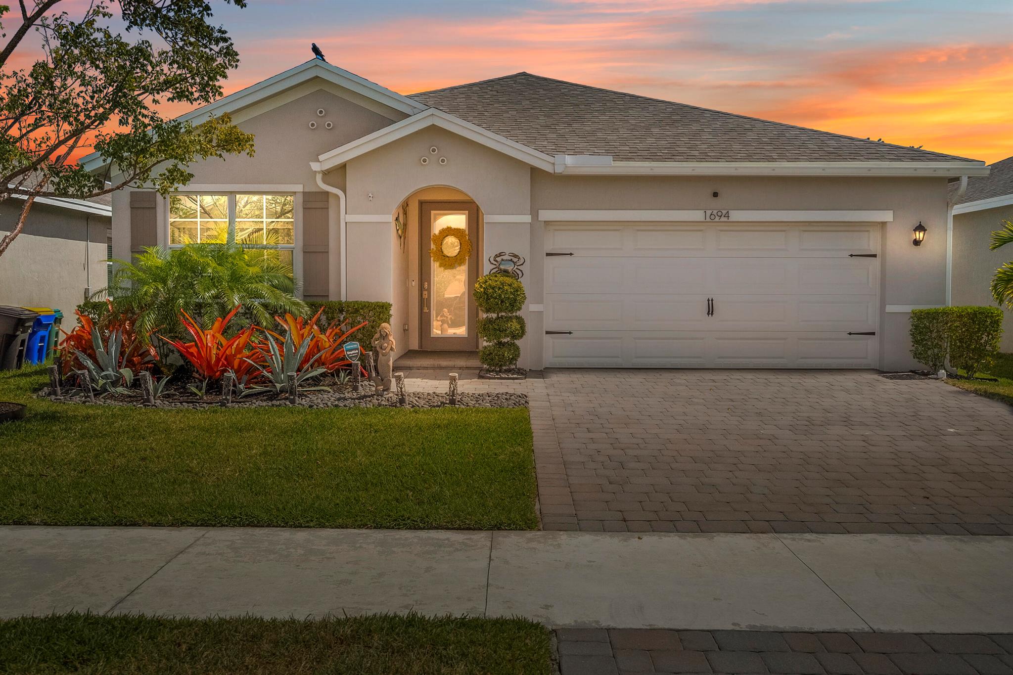 Come see this beautiful 3-bedroom 2 bath home built in 2020 located in the gated community of Seawalk.  The home has a custom heated salt water pool with travertine patio, lighting, waterfall jets, swim platform and screen cage.  Custom landscaping surrounds this property.  The 2-car garage offers new cabinetry, flooring and ceiling storage rack.  Inside there are many upgrades including wood plank tile throughout, crown molding, impact windows, full glass front door with impact glass and built-in blinds, ceiling fan in all rooms, stainless steel appliances, quartz countertops and island overlooking open concept living room and dining room.  Custom window treatments in every room.  New washer and dryer.  Unfurnished or furnished available.  Seawalk is less than 3 miles to Jensen Beach,