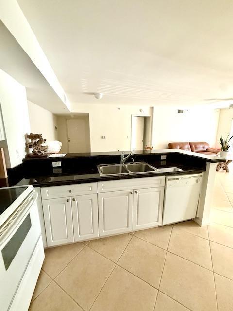 MOTIVATED SELLER. Unit is in move-in condition with split floor plan & two convenient parking spaces. Upgraded features include NEW - A/C, Hot Water Heater, Washer/Dryer, Fans, Window Treatments, Carpet, Paneled Doors, Custom Paint. Bathrooms have NEW shower, tile in tub, toilets, mirrors & flooring. There is an ADT Security System & full Accordion Shutters. Lighthouse Cove is a well-maintained community with recent upgrades including new roofs, painted exteriors & repaved parking lot. Resort-style amenities include: heated pool, fitness center, indoor racquetball, tennis, pickleball, billiards, grills & clubhouse. You can rent immediately upon ownership. Bring an Offer -