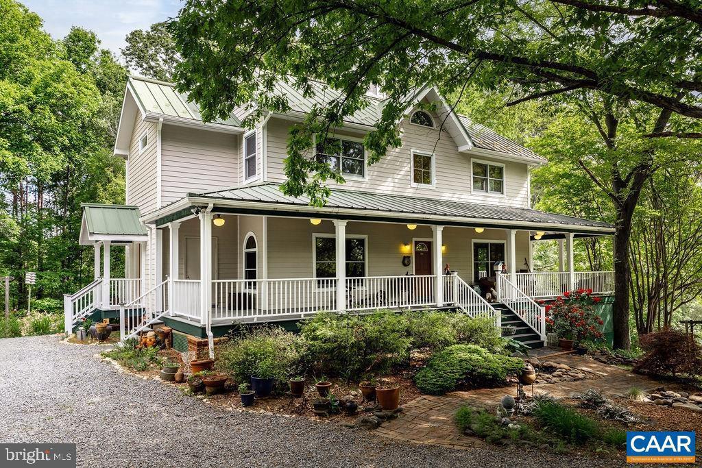 Welcome to Rooster Hill! Custom built 5 bedroom home on nearly 6 acres w/ mountain views located in the foothills of the Blue RidgeMountains. The modern farmhouse exterior has a wide wrap around covered porch - perfect for enjoying the property. Inside the house are 5 spaciousbedrooms, 4.5 baths spanning over 3600 sq ft. The 2 first-level bedrooms each have their own kitchenettes, bathrooms, entrances, parking, & outdoor space. Special Features include: energy-efficient solar power w/ 40 panels & a solar generator; 1 gig fiber internet access; spacious kitchen w/ quartz countertops; 2 walk-in pantries; solid oak hardwood floors; soapstone hearth & trim accents throughout home; custom built-in wall units, cabinets &closets; standing seam metal roof; EV charging station; walk-in roof top cupola; massive attic storage. The property also includes a separate workshop, greenhouse, fenced veggie garden, & adorable chicken coop. Great Western Albemarle school district. Convenient to Charlottesville, UVA, Crozet, shopping, local restaurants & schools. Enjoy the income potential by renting the 2 first-level rooms as these owners have or make a family compound. Purchase the adjoining acreage & rental home for more income or space.