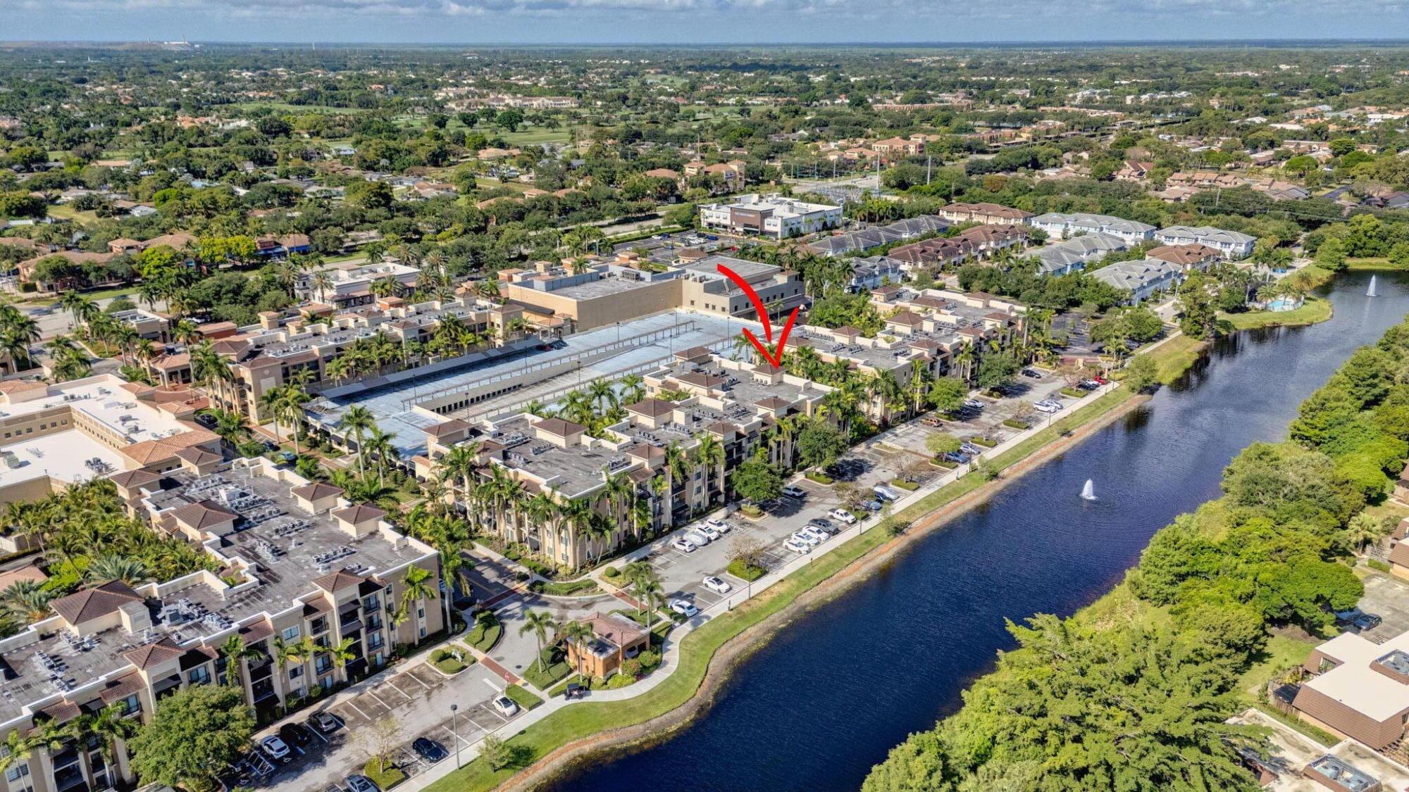 Pristine Turnkey condo beautifully furnished. Newer water heater, refrigerator, washer /dryer and microwave. Stunning wood like light porcelain tile throughout. Crown moldings, Hurricane impact windows leading to a relaxing balcony w/tropical & side water view. Gated community with secure building access & 2 elevators to this 3rd. floor condo.  Resort like clubhouse  w/ heated pool & spa , tennis, pickleball courts, fitness center, media center. Onsite Prop manager. Prime location in PBG adjacent to shops, restaurants,, supermarkets, I95 & Turnpike. Minutes from sandy beaches.