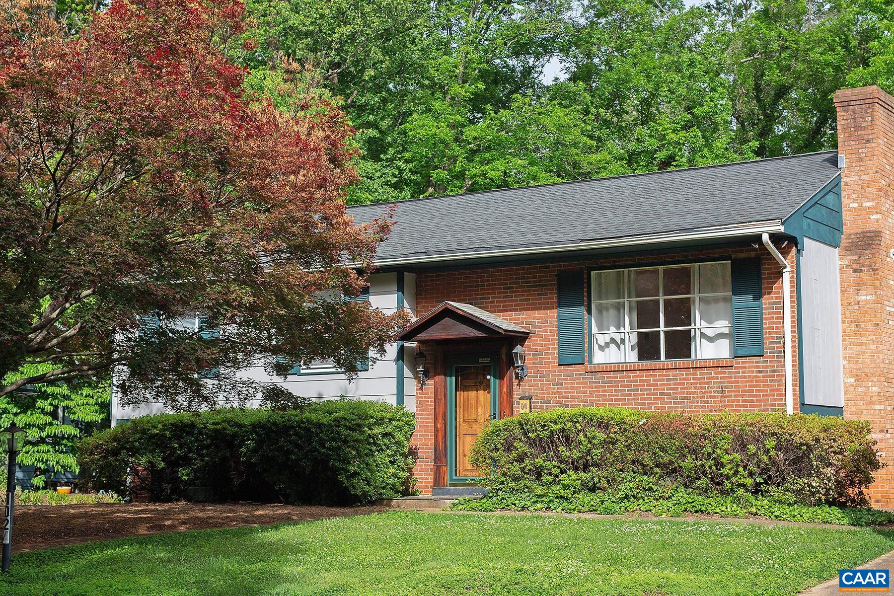 Tucked away on a quiet street, this 4 bedroom, 2.5 bath Locust Grove home sits on .20 acres and offers easy access to public parks, the Rivanna River, downtown, and the 250 bypass. Just a short drive from the University of Virginia, Rt 29, and I-64.    Enter this 1,889 sq.ft. split-foyer home and discover hardwood floors leading you into a bright living room, complete with a cozy wood-burning fireplace. The eat-in kitchen offers stainless steel and black appliances. A primary bedroom with a private half bath, along with two additional bedrooms, and a convenient hall bath complete this main level. The walk-out lower level offers versatility with a fourth bedroom or home office, a generous family room, a full bath, and unfinished space with laundry. Outside, relax on the new rear deck overlooking a wooded backdrop, or step onto the lower patio – an ideal spot for a firepit, grill, and picnic table. A detached one-car garage features a large finished area for home/business office space with a mini-split system, while the lower garage section provides an additional workshop space with high beams.
