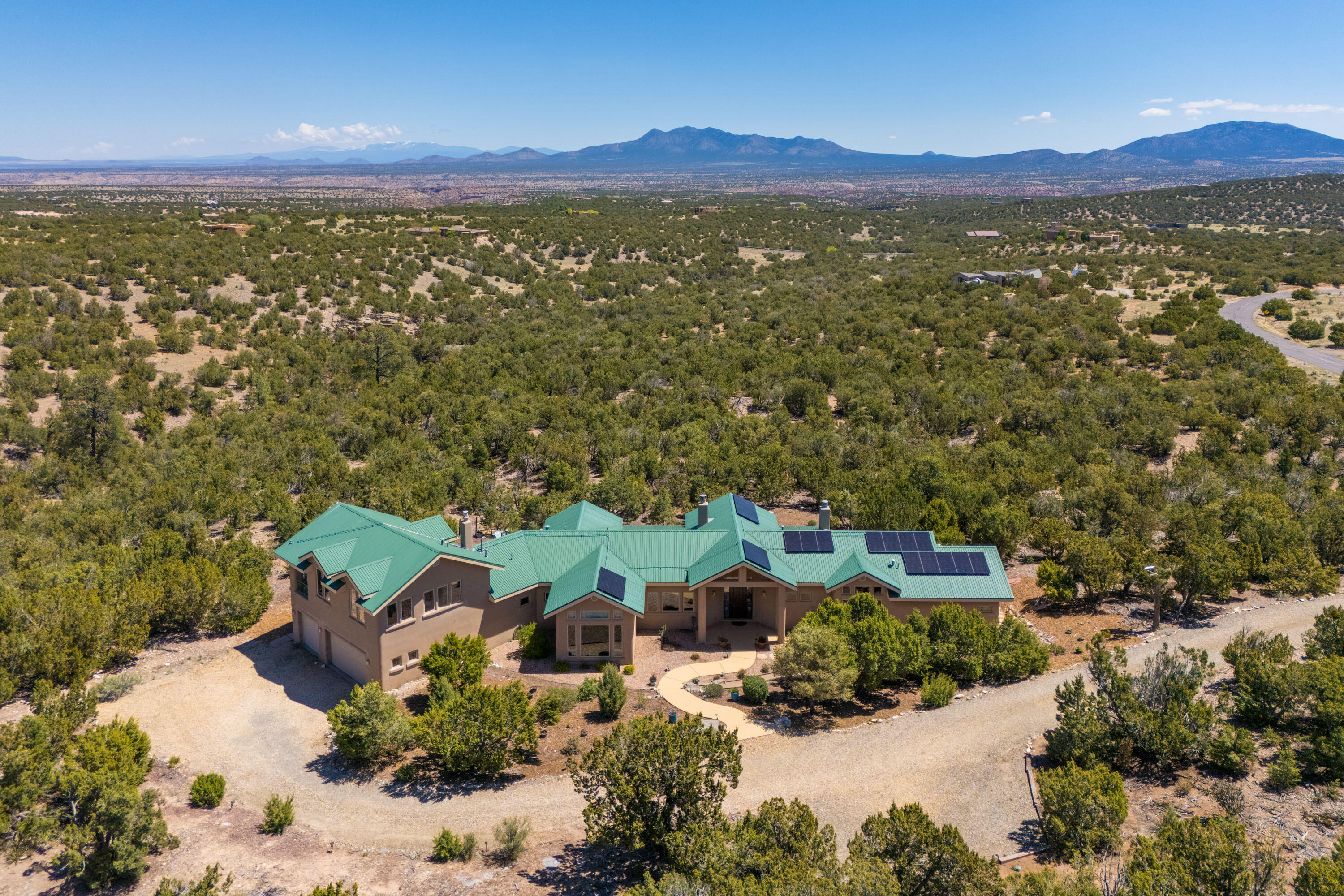 Discover unparalleled luxury in this remarkable 4 bdrm + office home, crafted by Crombie Construction, set on 10 pristine acres w/stunning mountain vistas.This exceptional residence features high ceilings, built-in cabinetry & expansive large windows that frame the picturesque views & flood the space w/natural light. Enjoy the seamless blend of elegance & functionality with a formal dining room & cozy breakfast nook. Primary Suite conveniently located on the main level, study w/floor-to-ceiling bookcases, 2 bedrooms w/sitting area upstairs. Covered porch for entertaining. Updated with solar electricity, Brazilian wood floors, fresh paint & new carpeting, this move-in ready masterpiece offers a perfect setting for an upscale lifestyle in a serene environment! Starlink high-speed internet!
