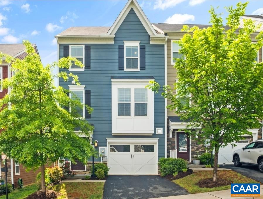 Enjoy modern living and breathtaking mountain views in this stylish end-unit townhome in the sought-after Avinity community! Just minutes from UVA, Downtown, and I-64, this home offers the perfect blend of comfort and convenience. The entry-level features a bright foyer and a flexible space with a full bath, ideal as a guest suite, office, or rec room. On the main level, enjoy open-concept living with a spacious great room, dining area, and gourmet kitchen with an oversized island and upgraded finishes. Step out to the rear deck, perfect for grilling or dining outdoors. Upstairs, the primary suite offers a walk-in closet and spa-like bath, along with two additional bedrooms, a full bath, and laundry. The top-level loft adds a cozy bonus space, perfect for a home office, and opens to your private rooftop deck with sweeping Carter Mountain views. Community amenities include a clubhouse, fitness center, dog park, playground, food trucks, and wine socials, plus you're close to Biscuit Run Park and Wegmans! Come see your new home today!