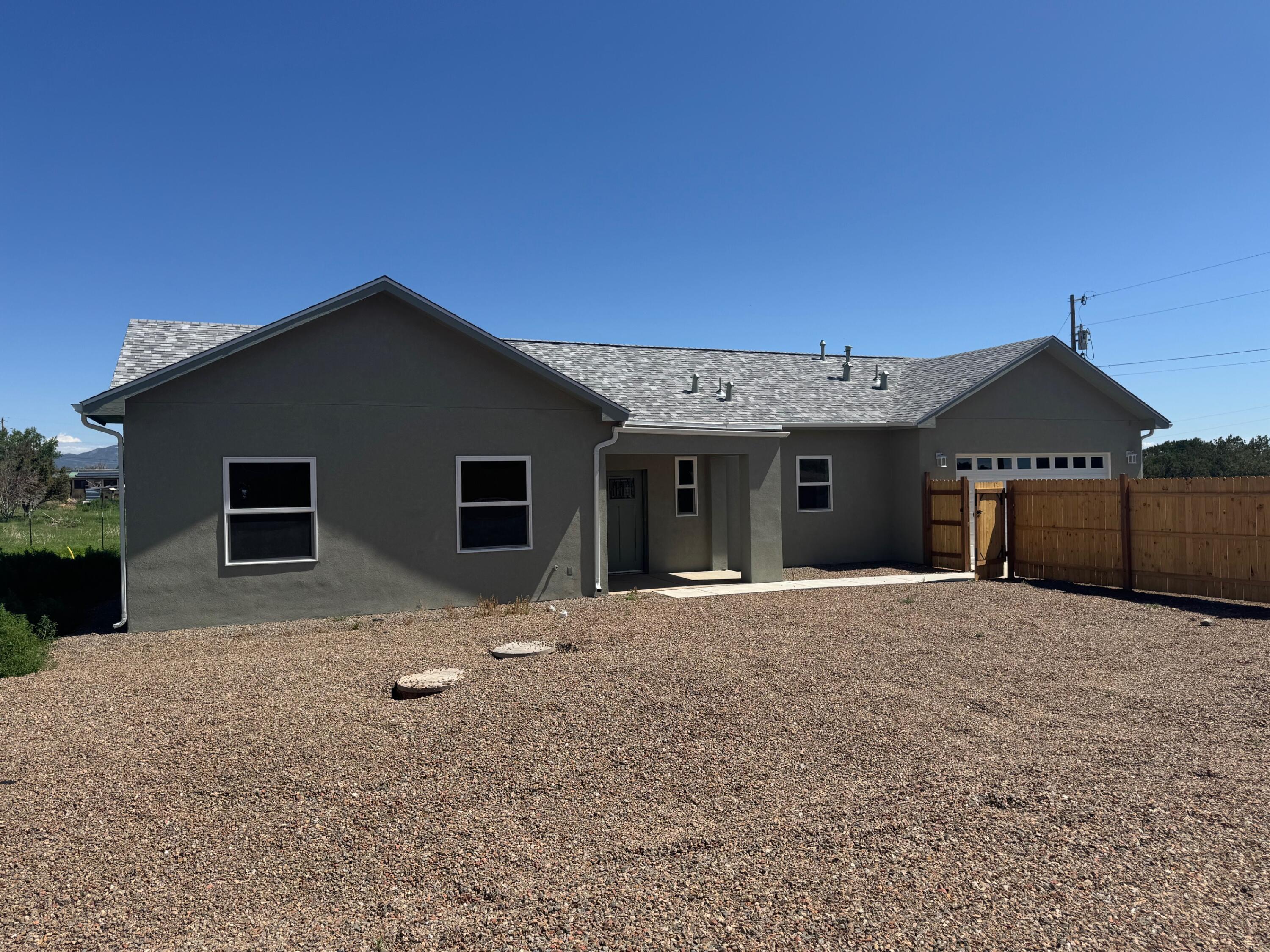Gorgeous BRAND NEW home sitting on 3/4 acres! Fully fenced! This light filled property features: Open floorpan with cathedral ceilings, NO carpet, Designer light fixtures, Chef's kitchen with bar for plenty of seating, large pantry, stunning granite countertops throughout, Primary suite with double sinks & walk-in closet, Auto lights in closets & pantry, Bathroom mirrors w/ dimmable lights & defog, Covered front patio, 2 car finished garage, Water softener & Natural gas.  Don't miss this one!!!