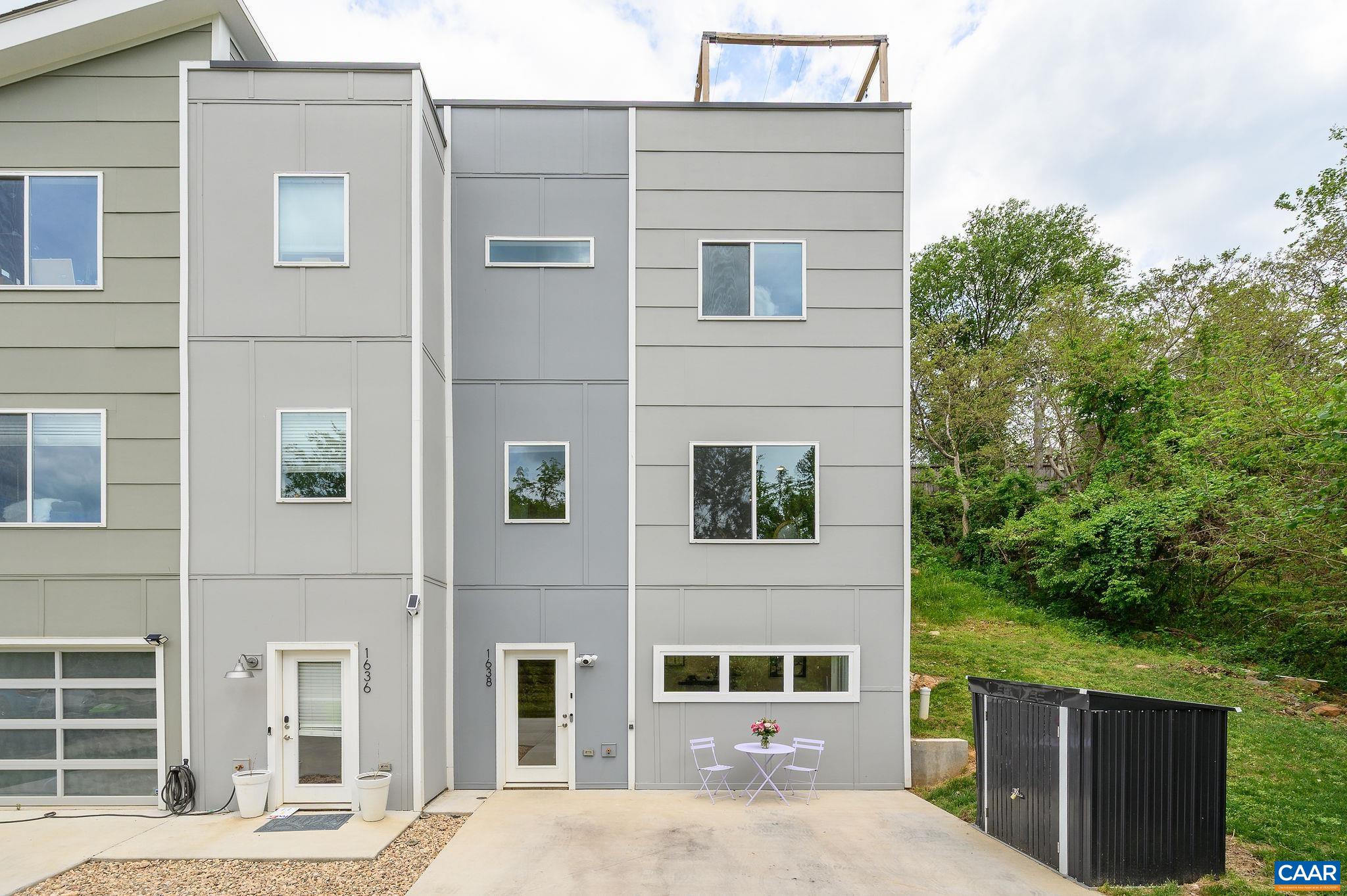Just steps from vibrant city living, this stylish, contemporary home sits peacefully on a quiet cul-de-sac, overlooking preserved city green space. Step onto the scenic, wooded Rivanna Trail to stroll along Moore's Creek, or head to the Downtown Mall, Belmont, Ix Park, or 5th Street Station—all walkable destinations. Nearly new, the home features large energy-efficient windows that flood the space with natural light, custom blinds and vaulted ceilings across three generous bedrooms. Stunning  oak floors span the top two levels. The popular open-concept layout seamlessly combines the Dining Room, Kitchen, and Living Room—ideal for entertaining or relaxed everyday life. Additional high-end features include a custom-designed kitchen (sleek grey cabinetry, quartz countertops, tile backsplash, and stainless-steel appliances) and upgraded baths (designer tile, frameless glass shower, and double vanity in the Primary Bath). The best part--the rooftop terrace!  It's the entire footprint--large enough for multiple seating areas; and mountain and greenspace views. Offering a perfect mix of nature and city convenience.