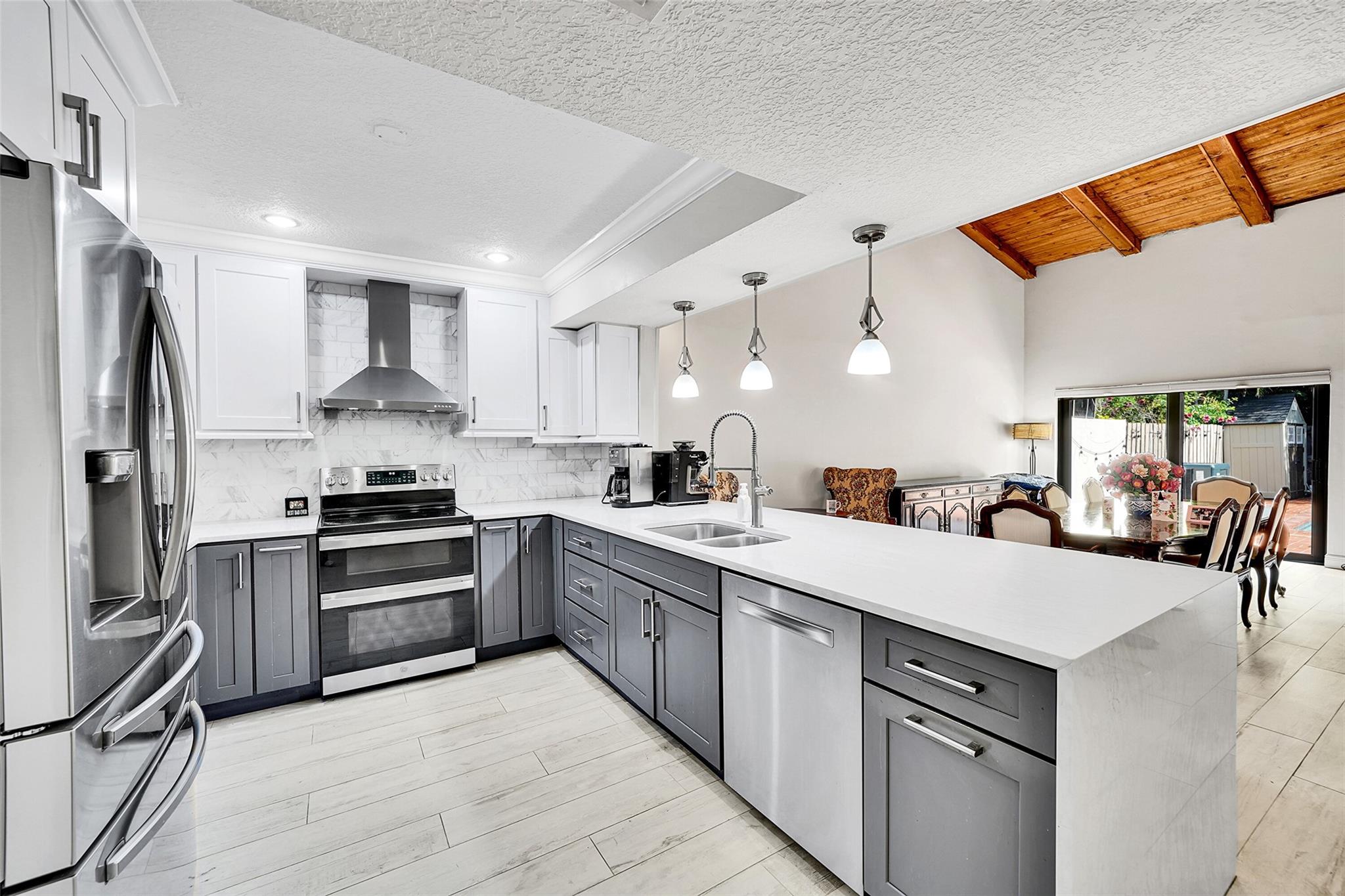 Welcome to 3319 Oak Drive, a rare gem in the desirable Tamerlane community of Hollywood, FL. This updated 3-bedroom, 2.5-bathroom townhome is ideally located directly across from TY Park, with easy access to major highways, the Hard Rock Hotel & Casino, and Emerald Hills Country Club. Step inside to an open-concept layout with soaring vaulted ceilings and skylights in both the living room and primary bedroom, filling the home with natural light. The fully renovated kitchen includes modern cabinetry, quartz countertops, stainless steel appliances, and a large island perfect for entertaining. Enjoy outdoor living in your own private pool — a rare find in this community. The home also features all impact windows and doors, a roof replaced in 2018, and a brand-new A/C unit installed in 2024.