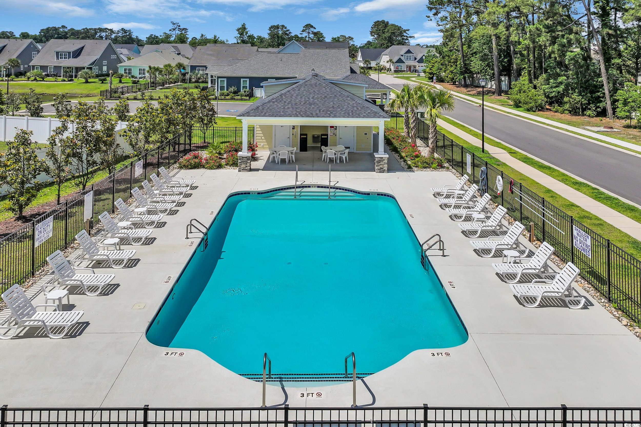 Community pool featuring a patio area and a residential view