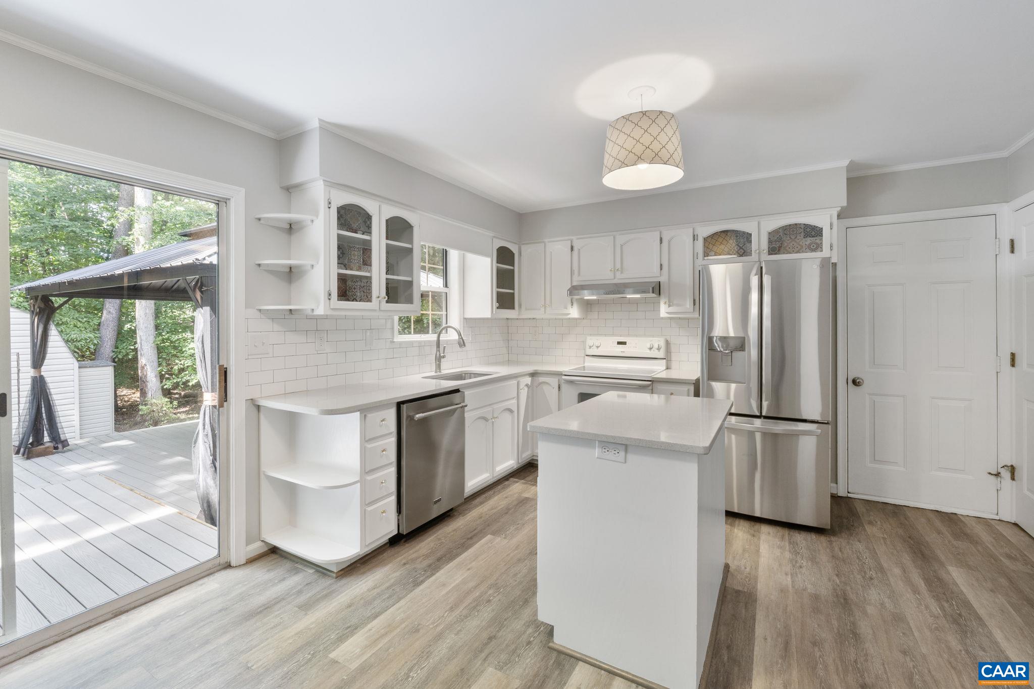 GREAT SPACES FOR INDOOR AND OUTDOOR LIVING! UPDATED PLUMBING. Welcome to this charming 4-bedroom, 2.5-bath Colonial located in the amenity-rich community of Forest Lakes! One of the areas most desirable neighborhoods. Beautifully updated throughout, this home perfectly blends comfort and style.  The updated kitchen features white cabinetry, quartz countertops, a central island for meal prep, and stainless steel appliances—ideal for the home chef. Adjacent to the kitchen, the spacious family room offers a cozy masonry wood-burning fireplace, perfect for relaxing evenings. Luxury vinyl plank flooring runs throughout the home, providing both elegance and durability. The upper-level primary suite is a true retreat, featuring a fully renovated ensuite bath with a double vanity and modern finishes. Separate dining and formal living areas. Enjoy outdoor living on the expansive multi-level Trex deck with a pergola—ideal for entertaining or relaxing with privacy. Additional features include a one-car garage and access to Forest Lakes' many community amenities, including pools, trails, and tennis courts.  Storage shed