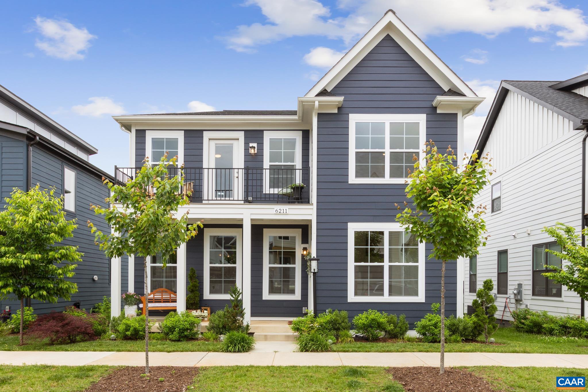 Exceptionally, well-maintained, beautifully designed home with detached Carriage House in Old Trail Village. Built 2023. Light filled and open main level featuring a welcoming foyer, elegant dining area, cozy great room with gas fireplace, & a chef-inspired kitchen complete with gas cooking, pantry, double-sided kitchen island tons of storage.  The detached carriage house with an ADU adds flexibility and value, offering a 1-bedroom apartment above the two-car garage—ideal for a home office, in-law suite, or rental opportunity. The possibilities are endless.  Outdoor spaces include an updated front porch with a covered roof, back deck off the kitchen and custom patio that is beautifully landscaped, with a walkway to the Carriage House and oversized 2 car garage.  Upstairs, there is a spacious primary suite boasting its own private deck, a generous walk-in closet, and ensuite bathroom. Two additional bedrooms, and a second full bath room with double vanity, and a side-by-side laundry room.  Enjoy life in a vibrant community just steps from walking trails, charming shops, local dining, a community pool, and a championship golf course. With fiber optic internet, Pearl Gold Certification.