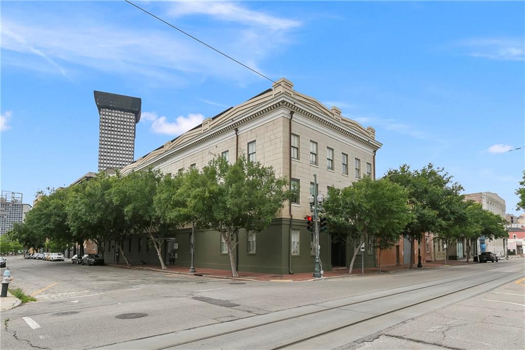 Fabulous 3 bedroom + study/2.5 bath condo with 2 Assigned Garage Parking Spots! Situated just one block away from the renowned St. Charles parade route, this exceptional corner unit offers a unique opportunity to own a spacious home created by combining two units. Open living areas are accented by exposed brick, elegant wood floors, and large windows that frame breathtaking views and flood the space with natural light. The generous eat-in kitchen boasts charming exposed brick, a sizable bar for casual dining, granite countertops, and stainless steel appliances. The master suite is a luxurious retreat with a beautifully appointed travertine bath, offering a perfect balance of comfort and style. A separate office space provides a dedicated area for work or study, enhancing the home's functionality. Residents of the building can enjoy exclusive access to a fitness room and a refreshing pool, perfect for relaxation and staying active right at home. Don't miss this opportunity to own a stunning condo that combines historic charm with modern amenities in a prime location near the heart of the city's vibrant festivities. Schedule a viewing today!