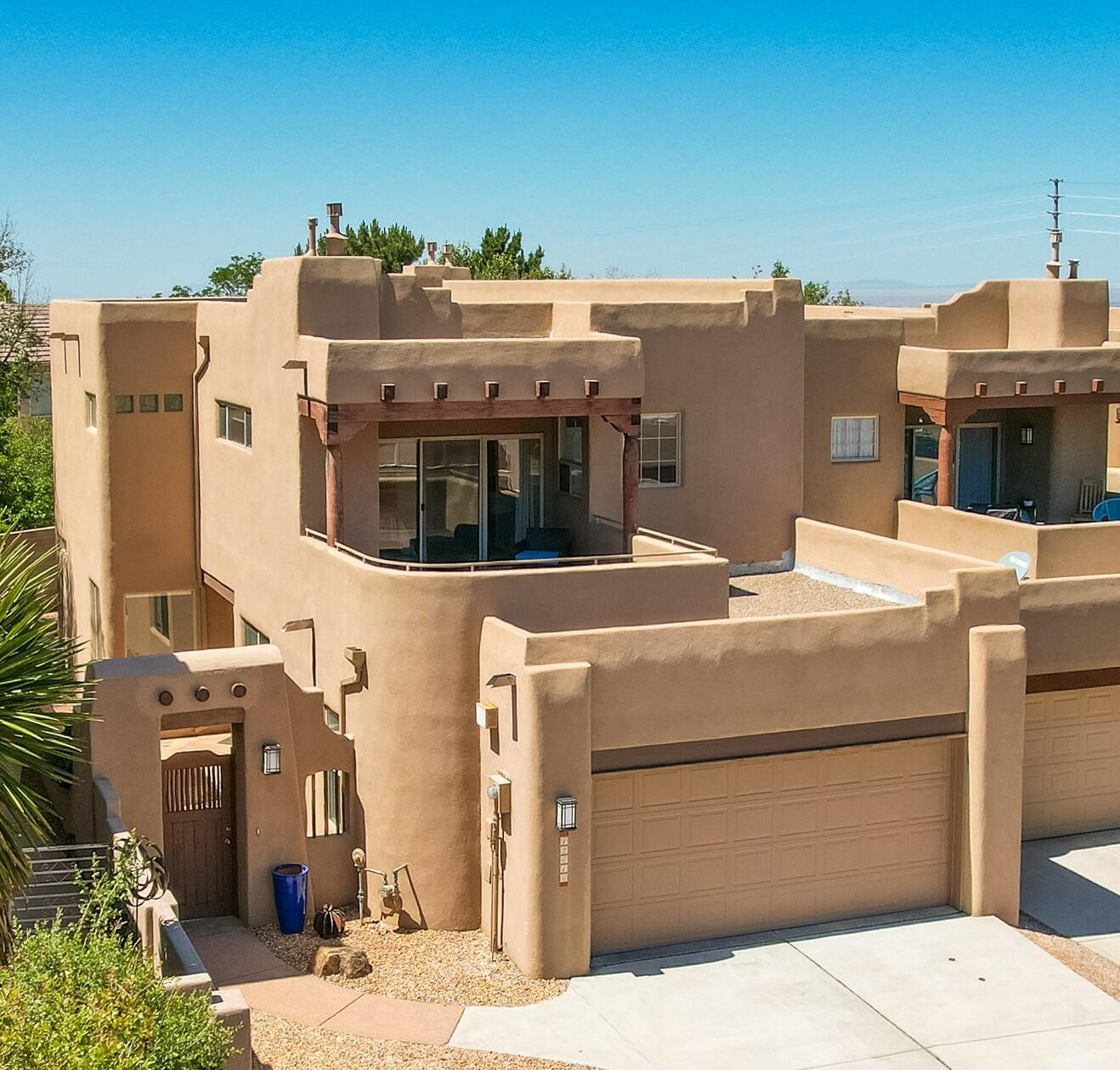 This High Desert townhouse is light &  bright w/ a functional open floor plan.  Enter home through a private courtyard gate.  1 bedroom on the main with use of 3/4 bath. Large living room has soaring ceilings w/ a stacked stone fireplace, wood accents & room for 2 sitting areas.  Primary bedroom features large, walk in closet, separate bath & shower plus 2 sink areas.  Sizable balcony w/ great views of the Sandias! Updated tile flooring, bathrooms & LED lighting throughout. Huge windows in LR - 2 have motorized blinds to help control temp.   Newer stainless oven, microwave & dishwasher. Newer water heater & furnace.  Location makes it an easy commute to most places in ABQ & offers easy access to both freeways.  Close to foothill trails & High Desert park w/ both tennis courts & playgr