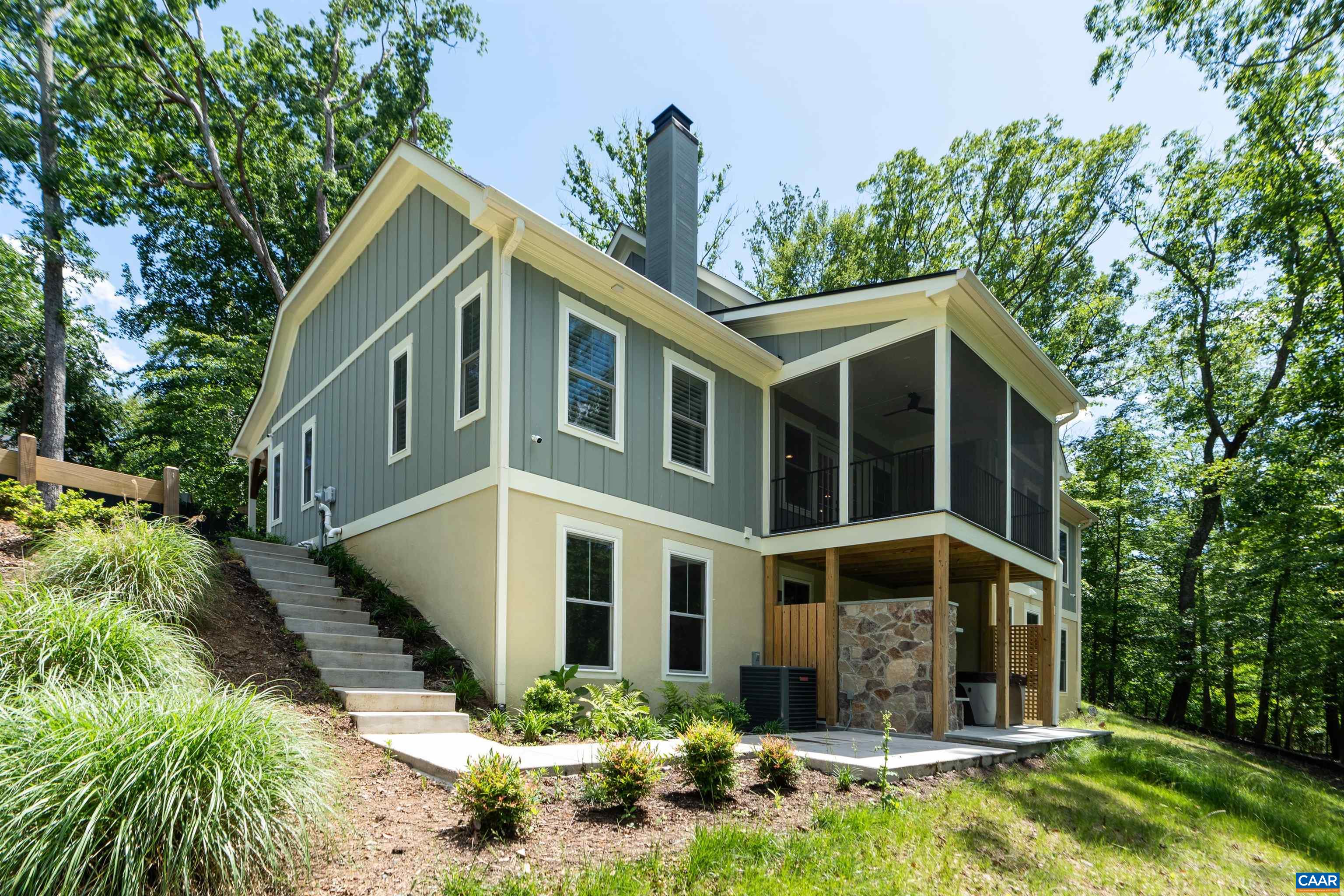 Experience refined living in this exceptional custom-built 2024 home located in the desirable Carrsbrook community. Set on 1.51 acres of serene, wooded landscape, this thoughtfully designed residence offers 5 bedrooms and 4.5 baths. Enjoy the ease of main-level living featuring rich hardwood floors, a stunning designer kitchen, and an open-concept living area centered around a cozy fireplace. Step on to the screened porch to take in peaceful wooded views. The elegant primary suite boasts a spa-inspired bathroom, creating a true private retreat. The fully finished walkout terrace level provides additional versatile space, including two rooms ideal for a home office, gym, or media room. Entertain outdoors on the patio with a built-in stone fireplace and hot tub.Conveniently located just minutes from UVA, Downtown Charlottesville, dining  and shopping.