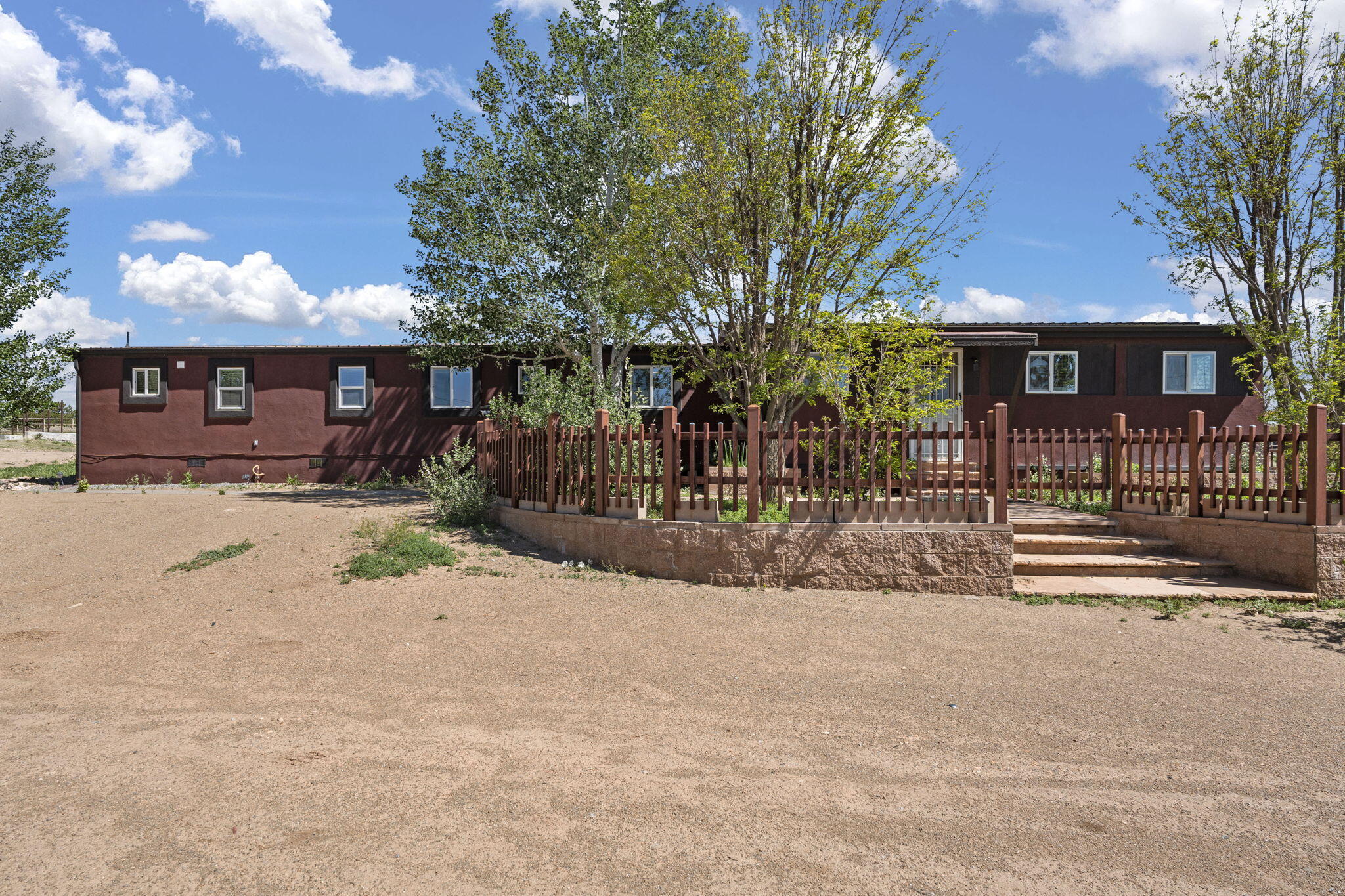 Welcome to this charming countryside retreat on a spacious 2.5 acre lot. This lovely 3 bedroom, 1 bathroom home offers 1,500 comfortable living space. This updated single wide offers modern amenities, including a stainless steel refrigerator, dishwasher, built-in electric stove, oven, and microwave. Enjoy refrigerated air conditioning, a durable metal roof, and a stucco exterior. The property also features a 40x39 barn with 4 horse stalls, ideal for equestrian enthusiasts or additional storage needs This property combines rural charm with modern amenities, making it perfect for those seeking tranquility and ample outdoor space. Whether you're a horse lover, gardener, or simply in search of a peaceful retreat, this home is sure to delight.