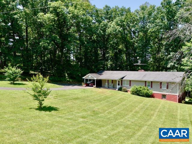 Minutes to top-rated Western Albemarle schools and Old Trail Golf Club! Discover this exceptional one-owner home on 2.49 private acres—just 15 minutes to UVA and minutes to the heart of Crozet for enjoying top rated dining, coffee shops, breweries & wineries. This property blends timeless charm, comfort, and privacy in a way that truly stands out. Enjoy excellent road frontage, ample parking, and thoughtfully designed spaces that are perfect for gathering with friends and family. Inside, arched doorways connect formal living and dining rooms to a warm, inviting kitchen featuring rich cherry cabinetry and gleaming hardwood floors. Skylights fill the home with natural light, highlighting the open floor plan ideal for entertaining. The finished walkout basement includes a private in-law suite boasting over 1000sqft of living space! It has it's own entrance, full bath, living room and kitchen — plus a large unfinished space for storage or future expansion. up to 4 BR, 6 person occupancy limit. Mature woods envelope the property creating a peaceful, natural setting. Shopping, local parks and hiking nearby. Very convenient to 1-64 and The Miller School of Albemarle as well. Seller will offer a cosmetic allowance with acceptable offer.