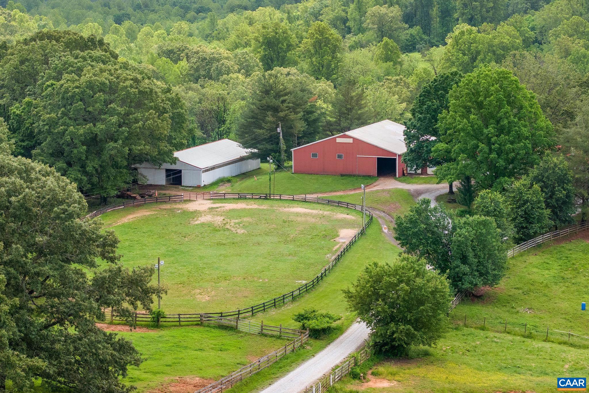 A Rare Equestrian Property on 47 Scenic Acres. This exceptional and well-established equestrian facility offers a unique opportunity for both personal enjoyment and business potential. The property includes a charming 2BR/3BA farmhouse and a separate 1BR/1BA barn apartment —perfect for trainers, or staff.  Barn 1 is a commercial-grade structure featuring a durable metal exterior, concrete block interior walls, 17 stalls, a wide center aisle, 2 tack rooms, a wash stall, feed room, hay loft, office, and bathroom. A second barn offers 13 stalls, a wide center aisle, tack room, ample storage, and workshop space. Equestrians will appreciate the attached indoor arena, the lighted outdoor arena, additional flat riding area and abundant pastureland. This turnkey facility is ideal for training, boarding, events, or private use—all set amidst rolling, picturesque countryside. At the heart of the property is a welcoming and easy-to-manage farmhouse that blends functionality with comfort. With two large ensuite bedrooms and a total of three full baths, this home offers flexible living space for family or guests. The property is a blend of practicality and natural beauty. Two creeks run through the land, adding to the charm.