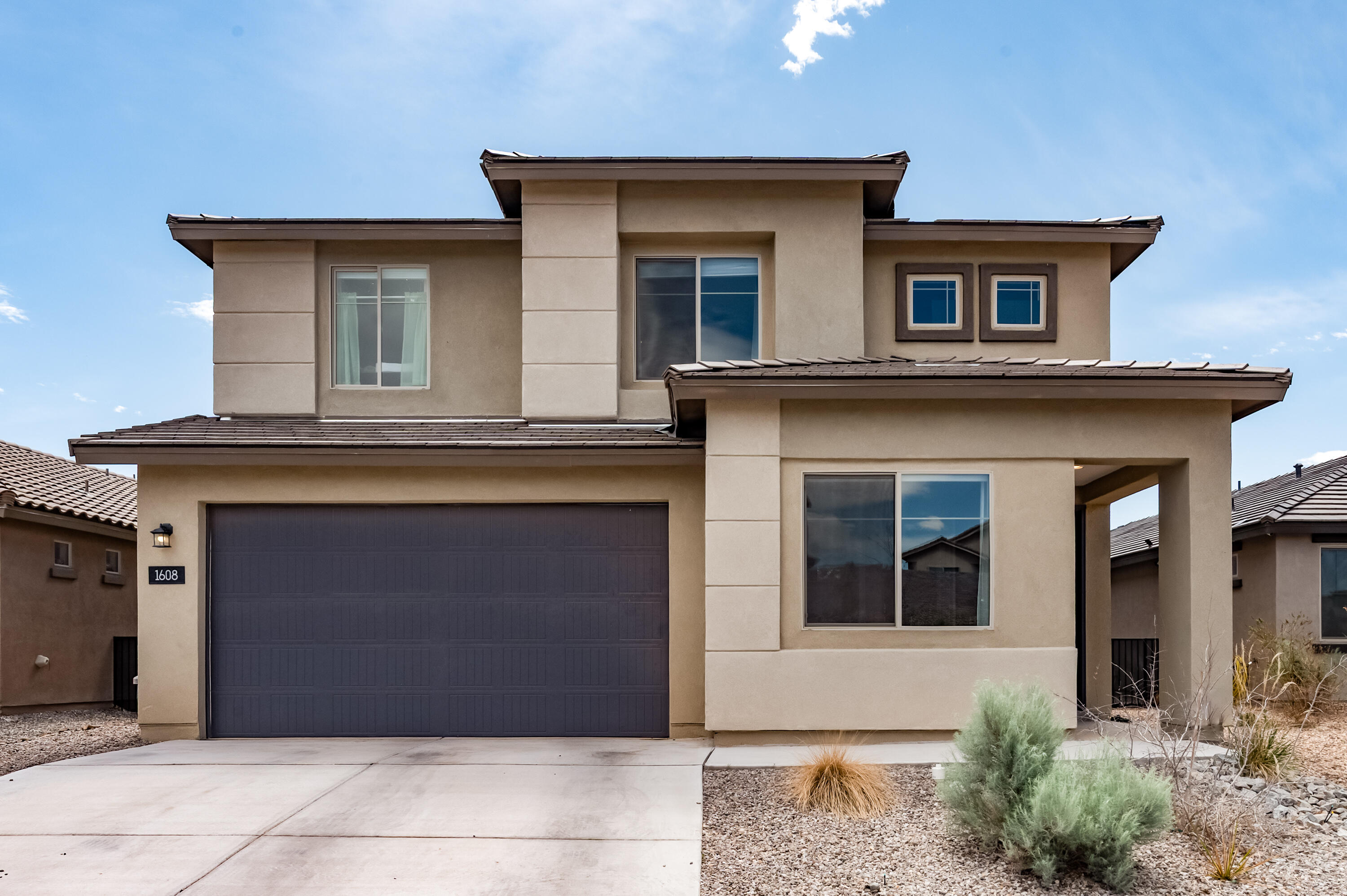 $14,000 price drop! Relocate to this Westside sanctuary in Inspiration Peak gated community, with a PARK, playground and basketball court.  TWO MINUTES to I-40, 15min to UNM, 13min to downtown, 5min to restaurants. Built in 2022, 5-bed 3-bath, 2-story, open-concept with upgraded finishes. Temperature Controlled GARAGE with epoxy-coated floors, TANKLESS water heater.  QUARTZ counter tops, GAS cooktop, large ISLAND with bar seating, walk-in pantry.  Wood-look luxury plank TILE and carpeted bedrooms/loft, abundant NATURAL light.Convenient downstairs guest suite with 3/4 bath. Upstairs LOFT, dedicated OFFICE space. His and hers WALK-IN closets, isolated lavatory, soaking tub, walk-in shower. UNOBSTRUCTED Panoramic mountain VIEWS! Fully XERISCAPED with Private putting green!