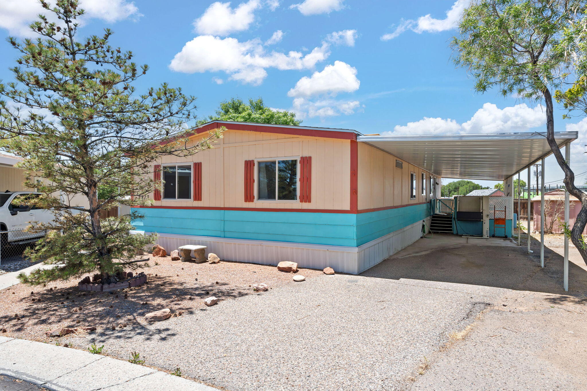 Back on market! Enjoy this lovely home in gated North Hills Mobile Home Park in NE Albuquerque. Must be 55+ to purchase and reside in NHMHP. This double-wide features 3 bedrooms & 2 bathrooms, offering ample space and comfort. Kitchen has been beautifully remodeled. Carpet is brand new throughout. Enjoy the convenience of a central location close to shopping, dining, recreation, & healthcare. Relax on the large back deck. The community boasts amenities like a clubhouse, swimming pool, and tennis courts--ideal for socializing and enjoying the North Hills lifestyle. All appliances are included, making this home move-in ready. Don't forget to explore the clubhouse & pool area during your visit! Gate closes at 9:00 PM. Office closes at 4:00 PM. Land lease is $656/month. No other HOA fees