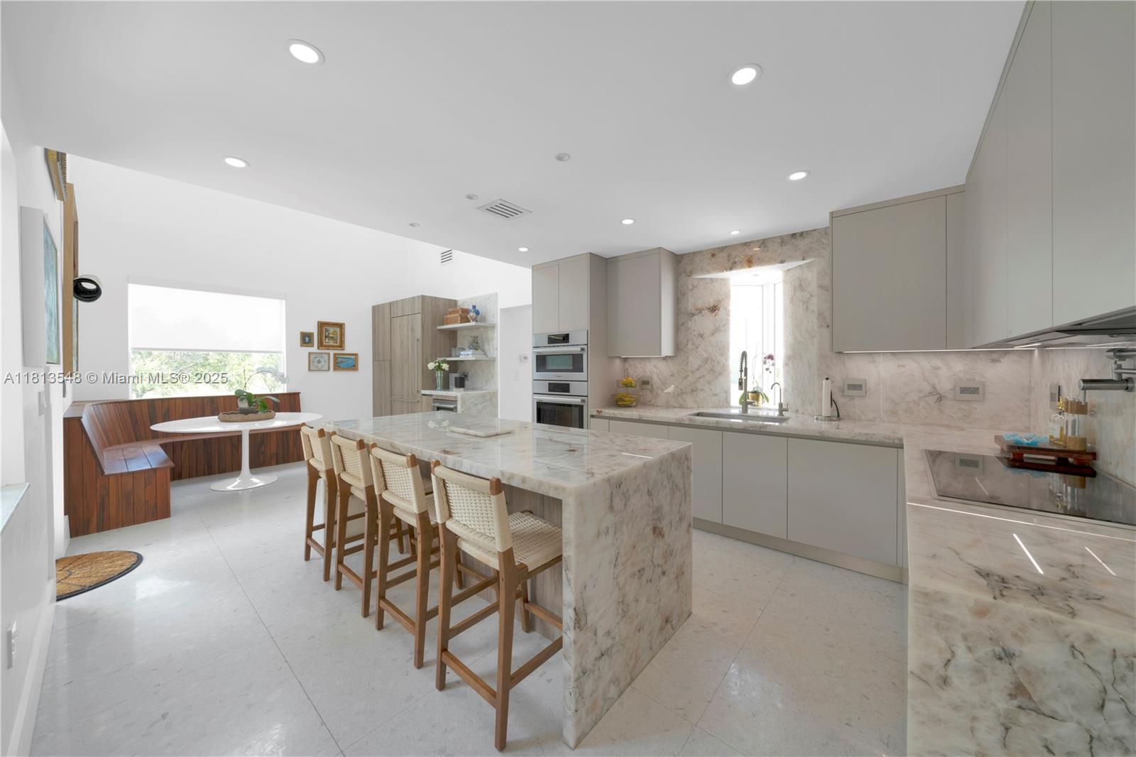 Casa Delfin is a move-in ready dream home, currently configured as a 5-bedroom, 5-bath residence 
Features elegant terrazzo and marble flooring, while the second floor and third-level studio/lounge boast rich, real wood floors. Two spacious roof decks offer stunning views of both the north marina and south green landscape.
Built in 1996 and engineered to withstand hurricanes, the home blends durability with luxury. The chef’s kitchen features Cristallo quartzite countertops, a Wolf induction stove, Sub-Zero refrigerator, and its own cozy lounge area with a custom-built dining nook. Additional highlights include updated bathrooms, a large backyard with a pool and  includes access to the marina and 8 deeded docks.
Located in a private, gated community with its own park.