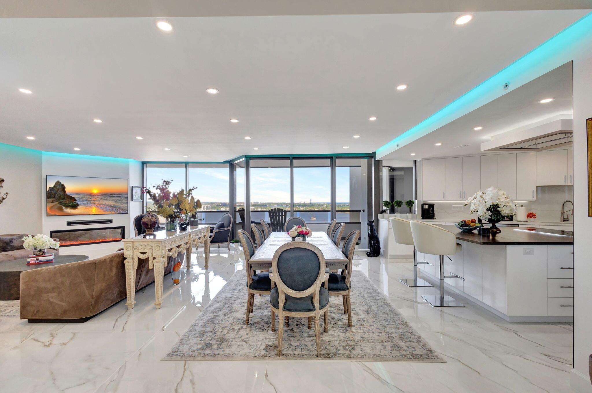 Welcome to Luxury living in Lake Point Tower. This stunning 2 bedroom, 2.5 bath condo offers breathtaking marina, intracoastal and ocean views. The north facing exposure is truly exceptional, offering year-round enjoyment without the need to shield your windows and obstruct the view. Enjoy a comfortably cool interior thanks to the desirable positioning of this condo, with reduced direct sun exposure creating a naturally temperate living space. Thoughtfully designed recessed LED lighting on dimmers brightens the home as needed, offering both energy efficiency and ambiance. The living room features custom cove lighting with over 2,000 color options, allowing you to set the perfect mood for any occasion. A sleek electric heater is integrated into a one-of-a-kind diagonally built accent wall, blending warmth and style in a truly distinctive way. To complement the raised ceilings in the bathrooms, walk-in closets, and laundry room, the ductwork has been upgraded with the latest technology to ensure optimal airflow and year-round comfort throughout the home. This meticulously renovated condo offers sophisticated upgrades, throughout, featuring a custom built kitchen; walk in closets with pocket doors,  fitted with California Closet designed shelves and cabinets;  steam room; laundry room, living room, and upgraded terrace flooring. The kitchen is a chef's dream, showcasing a custom built extra large center island with a unique wood looking grade 5 quartzite, Fulgar stovetop, perfect for both culinary creations and entertainment,  The kitchen is also fitted with custom designed cabinets including a full size corner curved cabinet offering maximum storage, complete with grade 5 elegant quartzite countertop and backsplash. High end appliances featuring a Sub-Zero refrigerator, Fulgar double oven, and a Best vent hood with external exhaust, complete the style and performance of this unique gourmet kitchen. The laundry room is thoughtfully outfitted with custom-built cabinetry, a high-capacity tankless water heater, a full-size washer and dryer, and a second refrigerator offering both functionality and convenience. Throughout the condo, you'll find impressive 42'' x 42'' tiles, adding a modern elegance to every room. The primary suite is a sanctuary, with a lavish bathroom featuring a spacious shower, separate steam/wet sauna, and floating vanities. With its custom design and premium finishes, it redefines luxury living. Lake Point Tower offers a state-of-the-art fitness center, a newly renovated pool and deck nearing completion, 24/7 concierge, and an on-site marina and restaurant. This is truly an unparalleled lifestyle in a prime location! Don't miss your chance to experience the ultimate in elegance and comfort. Schedule your private showing today!