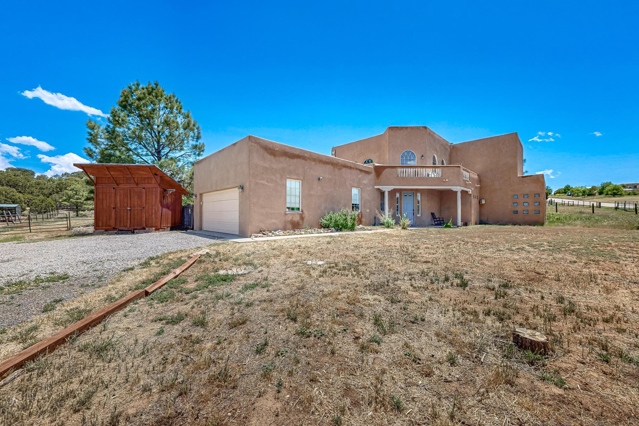 Gorgeous Mountain Retreat on 1.04 acre lot with VIEWS! Lovely 3 bed, 2.5 bath home with primary bedroom downstairs and 2 bedrooms upstairs. Soaring, beam ceilings in spacious living area with lots of natural light. Sunny, open kitchen with granite counters and stainless steel appliances with open counter for barstool area. Oversized primary bedroom w/ dream bathroom - soaker tub, walk-in closet and dual sinks. Fully fenced yard with backyard access and garden ready! Amazing views from upstairs balcony area. 2 car garage + two storage sheds for all your toys. Move-in ready!