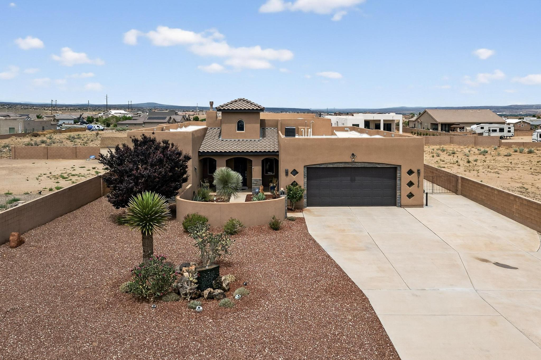 Wow! This home is quite EXCEPTIONAL!! Prepare to be captivated by this meticulously maintained 3 bed, 3 bath home with VIEWS in the sought-after Vista Entrada neighborhood. It offers a chefs dream gourmet kitchen with an impressive island, expansive great room floorplan, the primary suite, a true sanctuary with a spa-like bathroom including a luxurious walk in shower. Enjoy the outdoor space with a fully landscaped, low maintenance half-acre lot, charming courtyard, RV parking pad with hookups, and a spiral staircase up to a rooftop deck with breathtaking panoramic views, perfect for Fourth of July and Balloon Fiesta. The entertainers dream outdoor kitchen includes a grill, bar, mini fridge, sitting area, and outdoor TV. This home is your ultimate staycation retreat! It is a must see!!