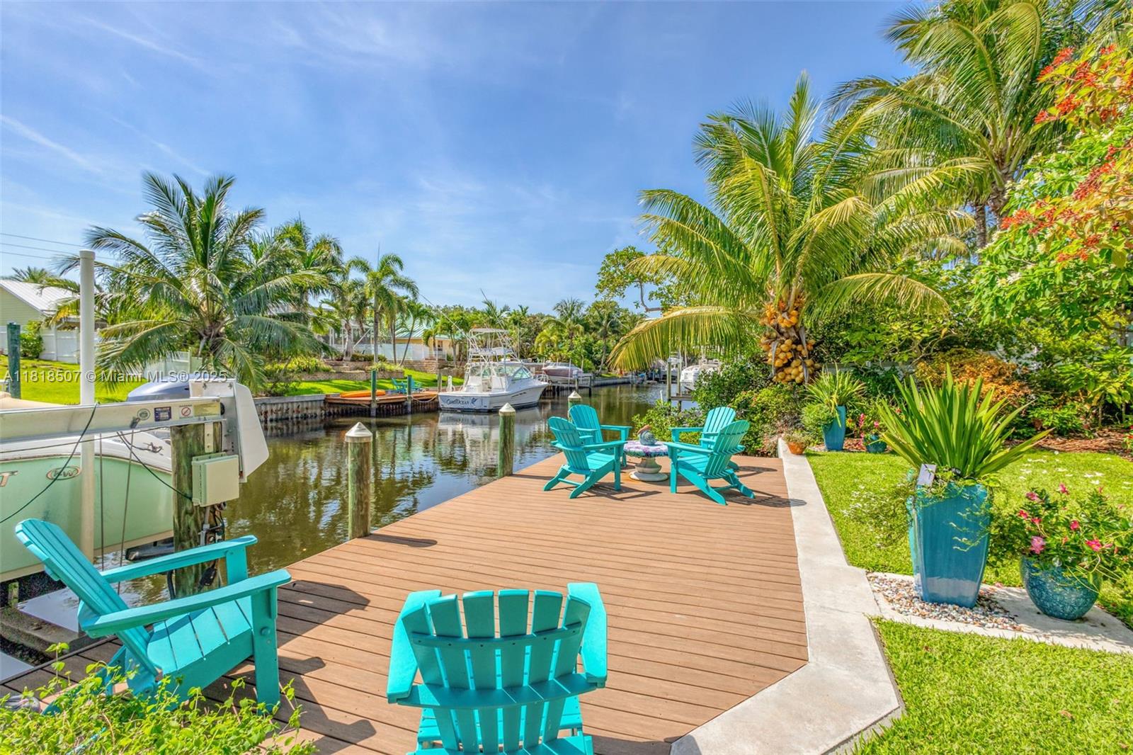 Welcome to an extraordinary opportunity in the most desirable safe, quiet neighborhood of the Gardens, a rare, exquisite 3-bedroom, 3-bath Art Deco waterfront gem that redefines waterfront living and serene sunsets. Boaters paradise and Outdoor living is exceptional here nestled on a 200-foot deep lot on oversized composite dock and 10,000# lift, with a sprawling 21,531 sqft including deeded canal bottom. Secluded canal with NO fixed bridges. The kitchen features sleek cabinets, elegant quartz countertops, stainless steel appliances and centerpiece 5-burner gas stove. 
The home boasts two master suites, each with own en suite bathroom designed to offer spa-like indulgence. Experience his and hers showers, accompanied by luxurious jetted tubs, perfect for relaxing after a long day. No HOA.