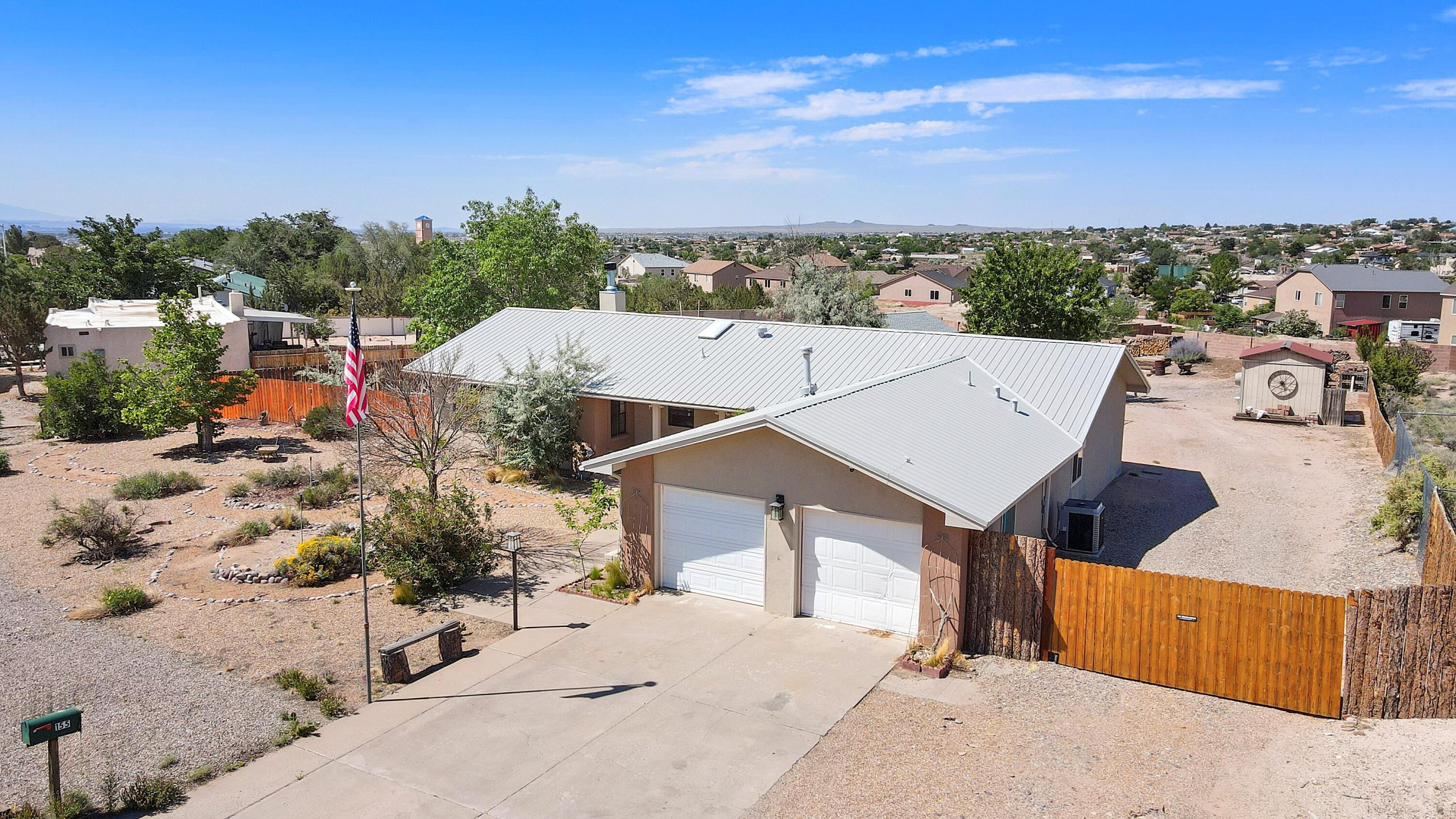 Step into this lovingly cared-for 3BD/2BA Rio Rancho haven and fall for its popular floorplan, dreamy sunroom--bathed in light and ready for morning coffee, creative moments, or quiet reflection. Nearly 1,900 sqft of charm, including a cozy fireplace that warms both heart and home. Out back, let your imagination roam--soak under the stars, dine on the patio, or tinker in the spacious workshop. With backyard access, there's plenty of room on this .5 acre lot for play, toys, or your wildest dreams. Thoughtful updates like a newer metal roof, stucco, WH, and refrigerated air offer peace of mind. Garage conversion adds space for a business, retreat, or hobbies--easily returned to a 2-car. NO HOA! Seller offering $3K in Buyers ''Flex Cash'' and Priced to enchant--come fall in love.