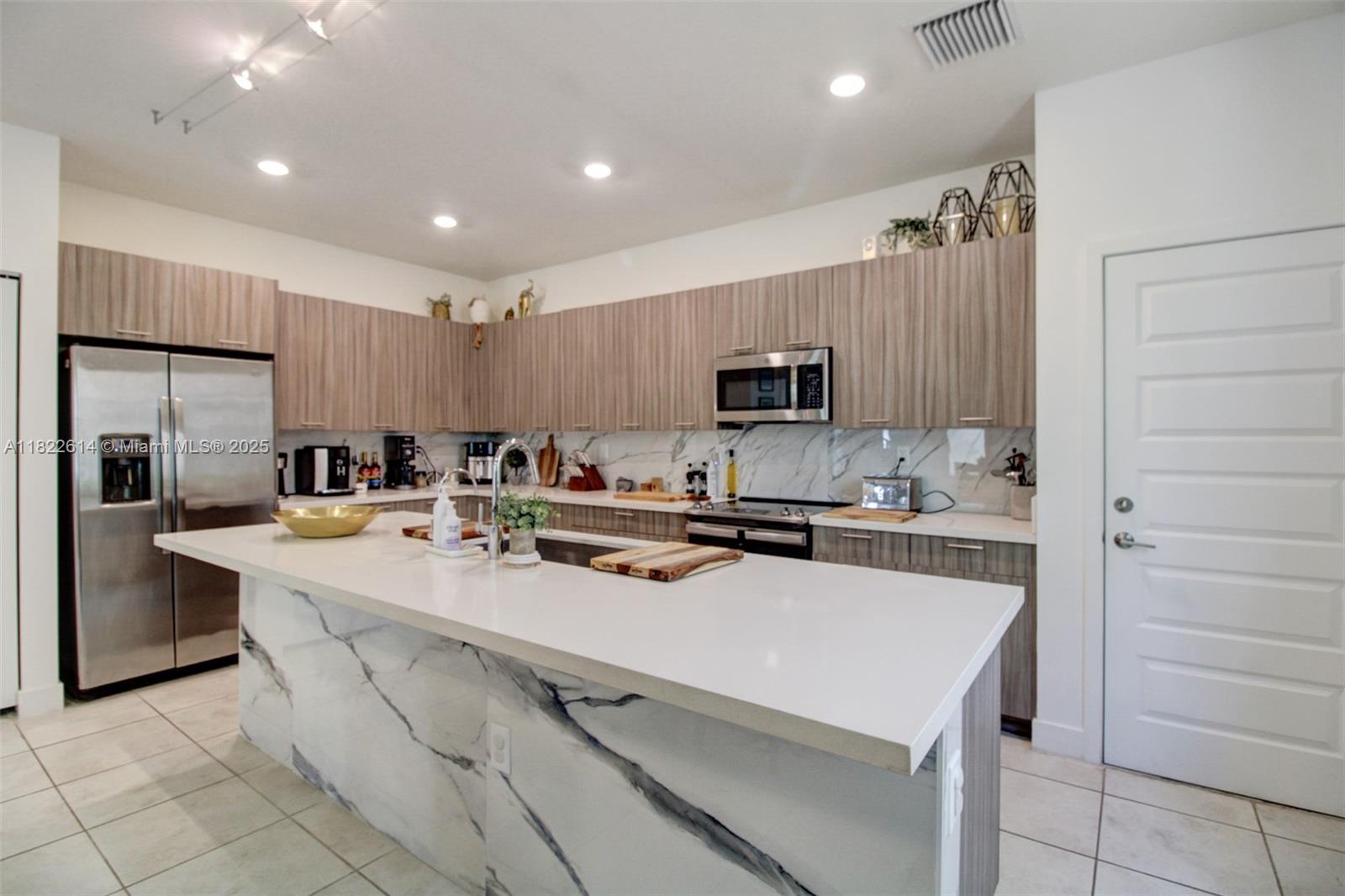 WALK to Downtown Doral Charter Elementary School.  Welcome to Urbana at Downtown Doral, a luxury corner tri-level townhome featuring 4 bedrooms, 2 full bathrooms, 2 half baths, and a spacious 2-car garage. Enjoy an open layout with a modern kitchen, oversized island, and plenty of cabinetry. A versatile loft/addi. room opens to a private rooftop patio with a built-in barbecue perfect for entertaining family and friends. Located just blocks from the upcoming Trump International Towers, and close to top-rated schools, dining, shops, parks, golf courses, and entertainment. Residents enjoy resort-style amenities, including a clubhouse, indoor basketball court, gym, running track, splash pad, pool, and event spaces