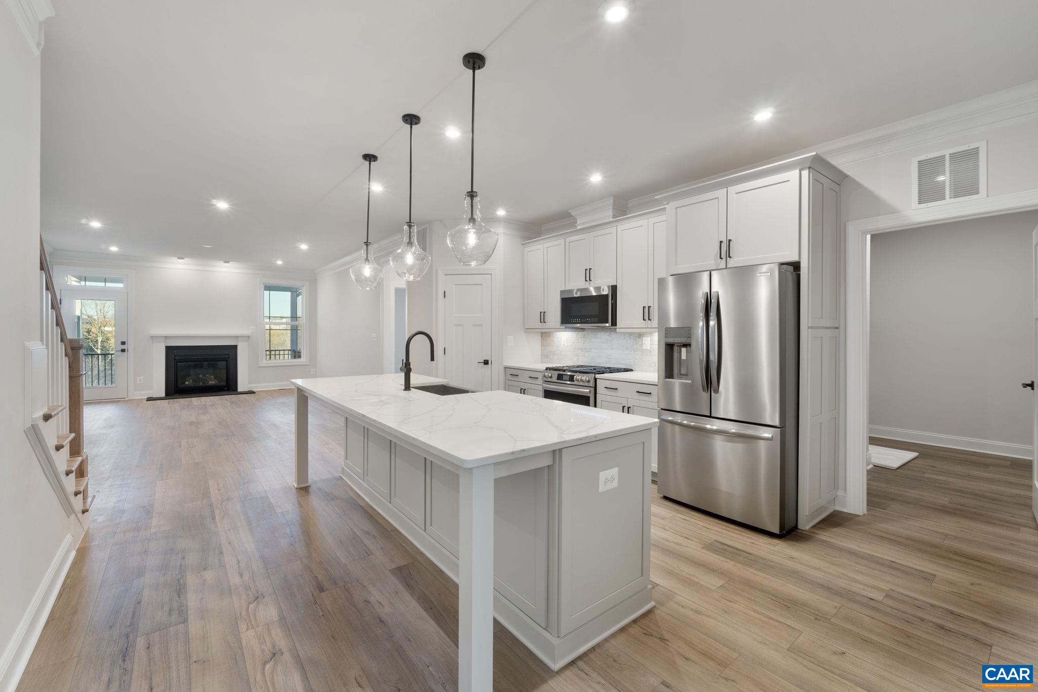 This stunning Bayberry villa in The Grove at Brookhill offers the perfect blend of luxury, comfort, and convenience - ready for immediate move-in! Nestled in a peaceful, wooded setting just off Route 29 North in Charlottesville, this home features a spacious main-level primary suite with a luxurious en suite bath and walk-in closet, an open-concept kitchen with quartz countertops, soft-close cabinetry, and a generous walk-in pantry, plus a cozy gas fireplace, mudroom, and main-level laundry. Upstairs you'll find two additional bedrooms, a full bath, loft, pocket office, and plenty of storage, while the screened porch off the family room is ideal for relaxing or entertaining. Built on a walkout basement foundation and complete with real stone accents and a two-car garage, this thoughtfully designed home is just minutes from the upcoming Brookhill Town Center with shopping, dining, and miles of scenic trails. Don’t miss this incredible opportunity to own a brand-new, move-in-ready home! Actual photos.