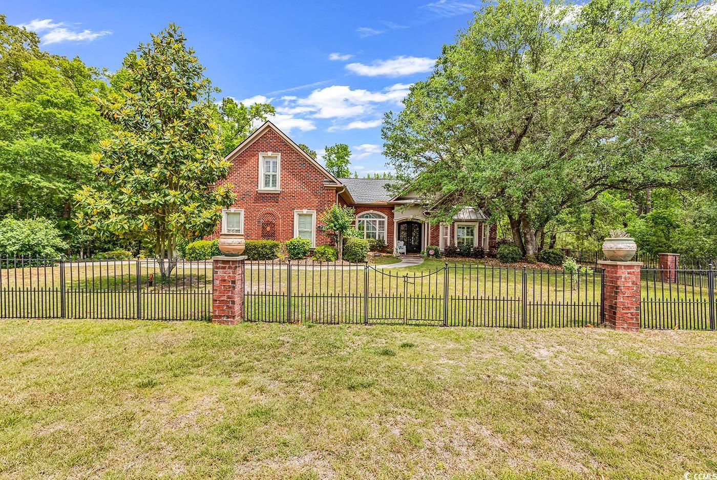 ****BIG PRICE ADJUSTMENT!!!****MOTIVATED SELLERS!!!****   Nestled on a serene and private 1.55-acre wooded lot in the Heritage Preserve community of Conway, South Carolina, this exquisite all-brick luxury estate blends timeless craftsmanship with modern sophistication. Designed for both grand entertaining and peaceful everyday living, this remarkable property features a total of 4 bedrooms, 4 full bathrooms, 2 half baths, and a 1,430 heated square foot guest house with an upper-level studio apartment—offering a rare blend of elegance, comfort, and versatility. Step inside the main home and discover refined interiors where granite countertops grace every surface, and thoughtful design meets high-end finishes at every turn. The primary bedroom and the two other first level bedrooms are their own private retreats, each with a full bathroom, jetted tub, and walk-in closet, ensuring comfort and privacy for family and guests alike. The heart of the home is the spacious gourmet kitchen, a chef’s dream with stainless steel appliances, double wall ovens, built-in wine cooler and microwave, a gas cooktop paired with a pot filler faucet, and a large center island.  The sunny breakfast nook overlooks the backyard oasis, making every morning feel like a retreat. Custom plantation-style blinds add an elegant touch throughout the home, while soaring ceilings and an open layout make every space feel light and inviting. Out back, an in-ground saltwater pool shimmers beneath the Carolina sun, perfectly framed by mature trees for the ultimate private escape. Whether you’re hosting summer pool parties or enjoying a quiet sunset swim, this outdoor space is perfect for it. For guests, extended family, or creative workspaces, the guest house offers 1,430 heated square feet of beautifully finished space, including a studio apartment upstairs—ideal for multigenerational living.  Both the main home and guest house boast newer (2021) 50-year architectural roofs, offering peace of mind and long-term durability. Additional premium features include an oversized two-car side-load garage, whole-home natural gas generator, natural gas tankless water heaters, new American made central vacuum system and more upgrades than can be listed. This home was built for ease, style, and comfort—with no detail overlooked. Heritage Preserve is known for its quiet, natural setting, yet it's just minutes from the charming streets of downtown Conway and a short drive to the beaches, dining, shopping, and entertainment of the Grand Strand Beaches. This is more than a home—it’s a legacy property. A private estate where memories are made, and life is lived to the fullest. Experience upscale Lowcountry living where nature, luxury, and craftsmanship converge. This is the lifestyle you deserve in this one-of-a-kind property a rare and remarkable find.