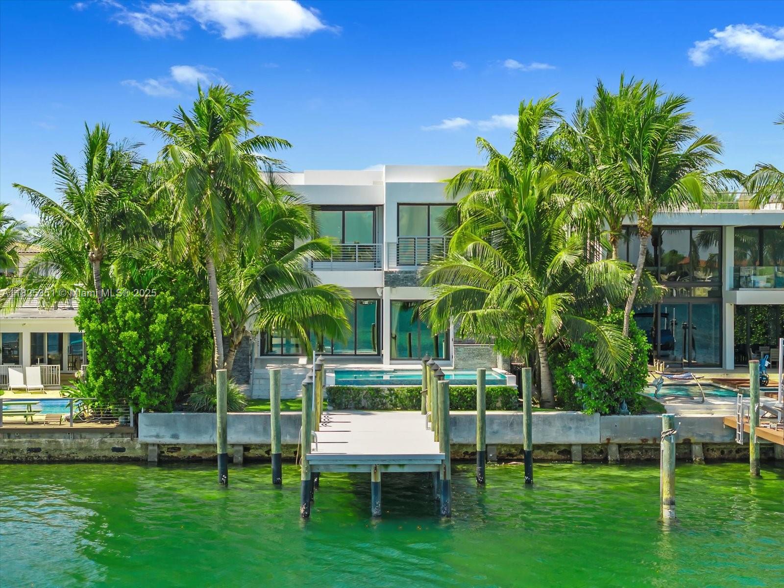 This magnificent modern masterpiece in the prestigious Stillwater Dr guard-gated community at Biscayne Point. This spectacular residence was built in 2021, this home offers a sleek and contemporary design with meticulous attention to detail and high-end finishes throughout, this property sets a new standard for luxury living. The home features a brand new dock and seawall, providing convenient access to the water.  A spacious and open floor plan, perfect for entertaining and modern living. From the custom cabinetry to the top-of-the-line  Miele appliances, ample storage space, and a large center island with seating. This modern masterpiece, along with its stunning rooftop showcasing 360-degree views, provides an unmatched level of luxury, elegance, and outdoor entertainment options.